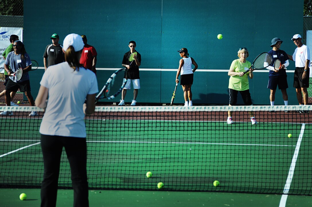 Several tennis professionals joined Airmen and their families at Joint Base Andrews, Md., Oct. 5, 2013, to give back through the Thanking Our Troops Through Tennis event.  Team Andrews members gathered to sharpen their game and play a friendly game or two at the base tennis courts. (U.S. Air Force photo/Airman 1st Class Joshua Dewberry)