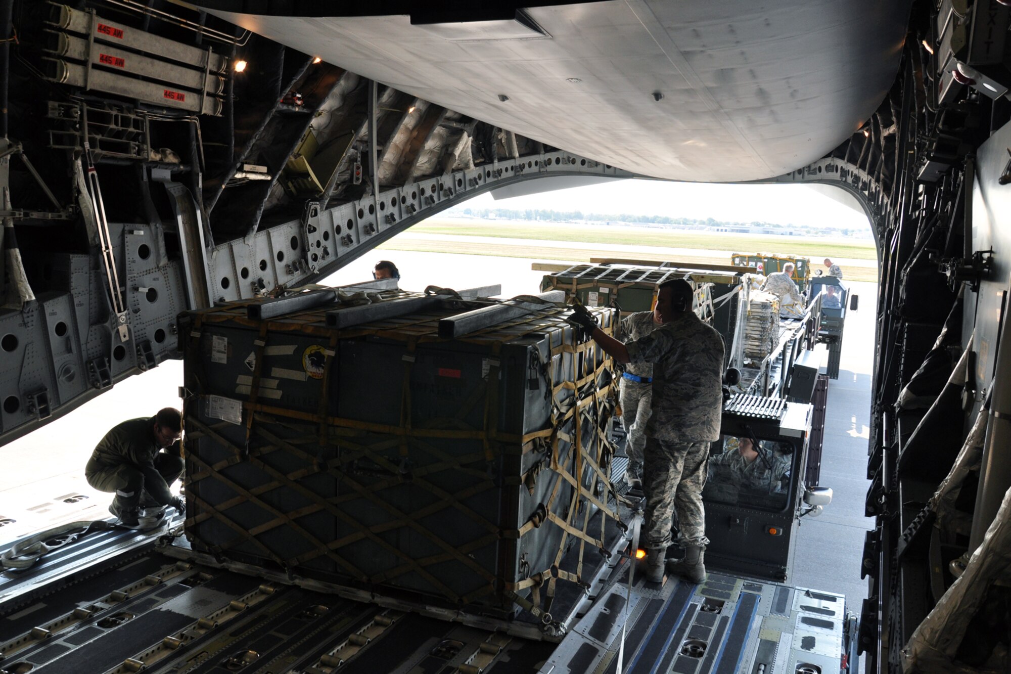 WRIGHT-PATTERSON AIR FORCE BASE, Ohio - Airmen from the 87th Aerial Port Squadron use a K-loader and work as a team to move eight pallets of supplies into the cargo area of a 445th Airlift Wing C-17 Globemaster III during the wing's Sept. 7 unit training assembly. (U.S. Air Force photo/Senior Airman Matthew Cook)