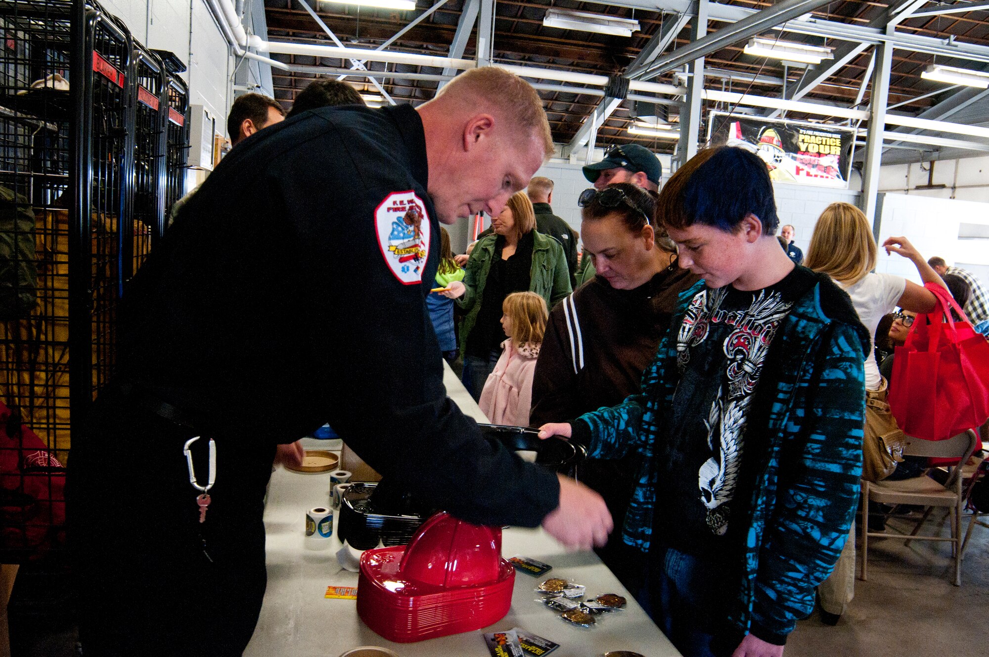 Army Spc. Brody Schnell, Wyoming National Guard Detachment 53 aviation operations specialist, introduces his son, Kasey, to Sparky the Fire Dog during an open house in F.E. Warren Fire Station 2 Oct. 5, 2013. Firefighters helped provide fire prevention education to guests who were treated to lunch and a choice of pumpkins for kids to carve later for Halloween, both provided by Balfour Beatty Communities. (U.S. Air Force photo by Airman 1st Class Jason Wiese)