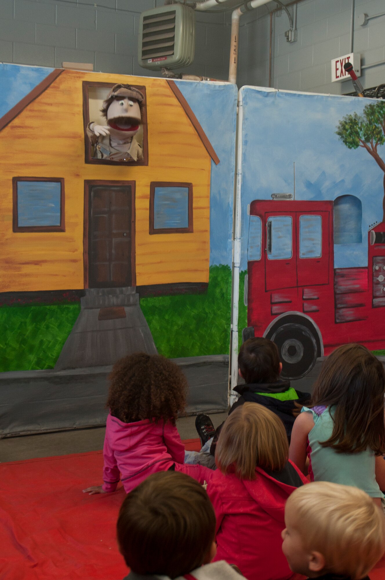Ninetieth Civil Engineer Squadron firefighters put on a puppet show for children attending their fire department open house in F.E. Warren Fire Station 2 Oct. 5, 2013. The show taught the children about fire safety using a medium to which they relate. (U.S. Air Force photo by Airman 1st Class Jason Wiese)