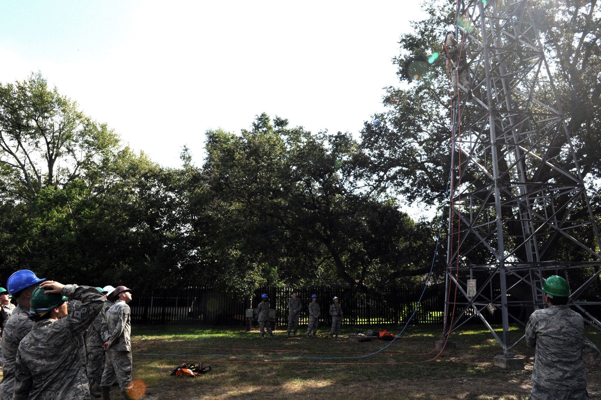 Members of the 81st Training Wing leadership watch as 85th Engineering Installation Squadron personnel climb a training tower for a demonstration of a tower rescue maneuver during the 85th EIS open house Oct. 3, 2013, Keesler Air Force Base, Miss. The open house was held to educate leadership on the unique services and day-to-day operations of the Air Force’s only active duty engineering installation squadron. (U.S. Air Force photo by Airman 1st Class Stephan Coleman)