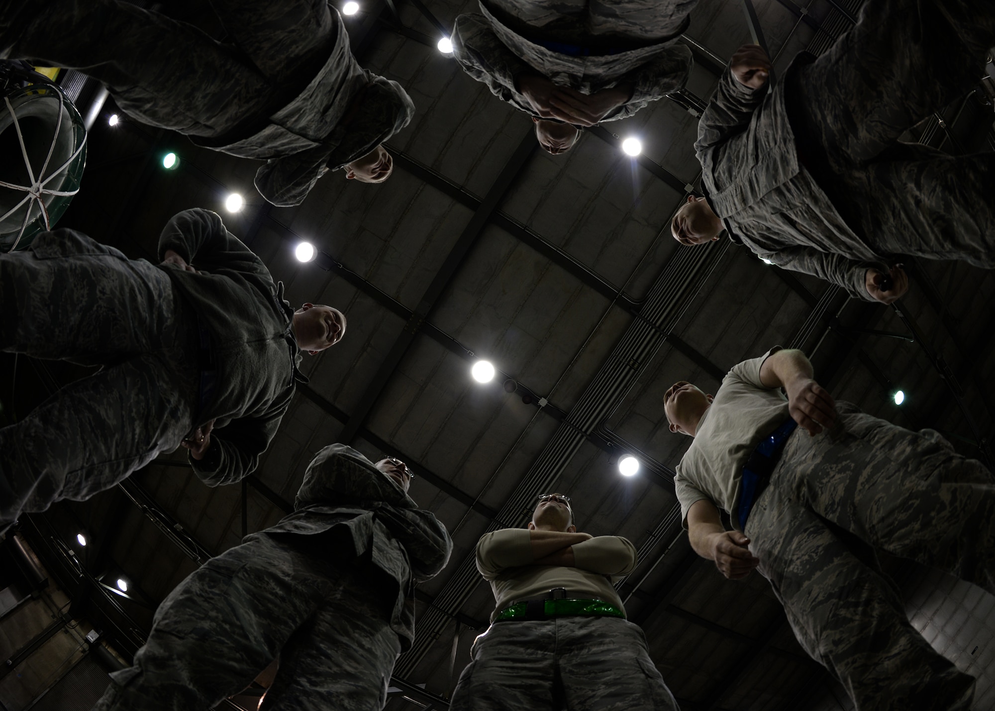 The 354th Maintenance Squadron propulsion flight has a safety huddle at the “Hush House” prior to an engine test Oct. 3, 2013, Eielson Air Force Base, Alaska. Because of the deafening sound during the test, most communication is directed prior to the test. (U.S. Air Force photo by Senior Airman Shawn Nickel/Released)