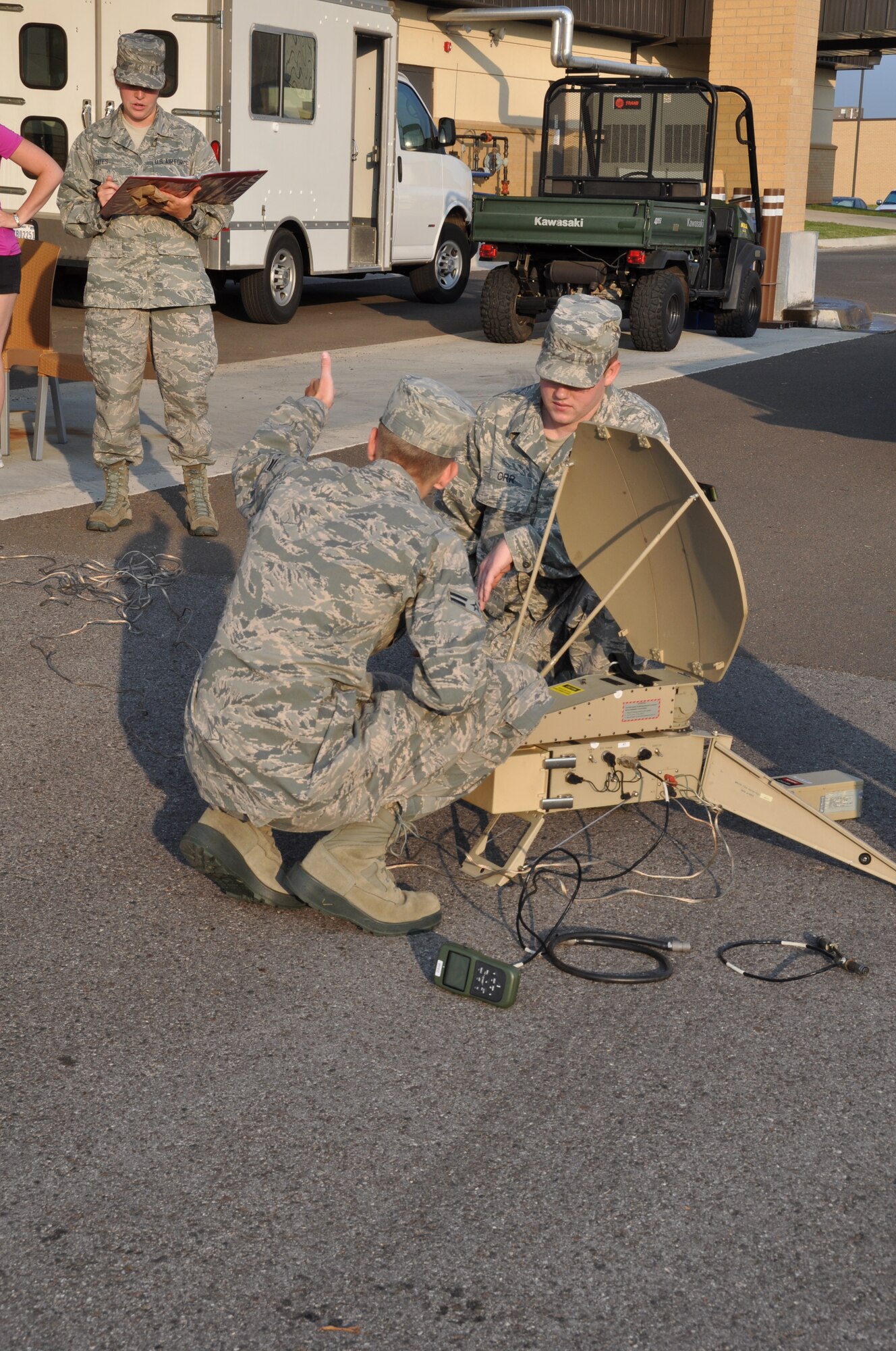 Airman 1st Class Christopher Capraro, 137th Air Refueling Wing Command Post, Oklahoma Air National Guard and Staff Sgt. Erik Orr, 507th ARW Command Post set up Anti-Jam communication equipment while Airman Natalie Gates, 507th ARW CP runs the checklist in support of the training here Sept. 13.  (U.S. Air Force Photo/Maj. Jon Quinlan)  