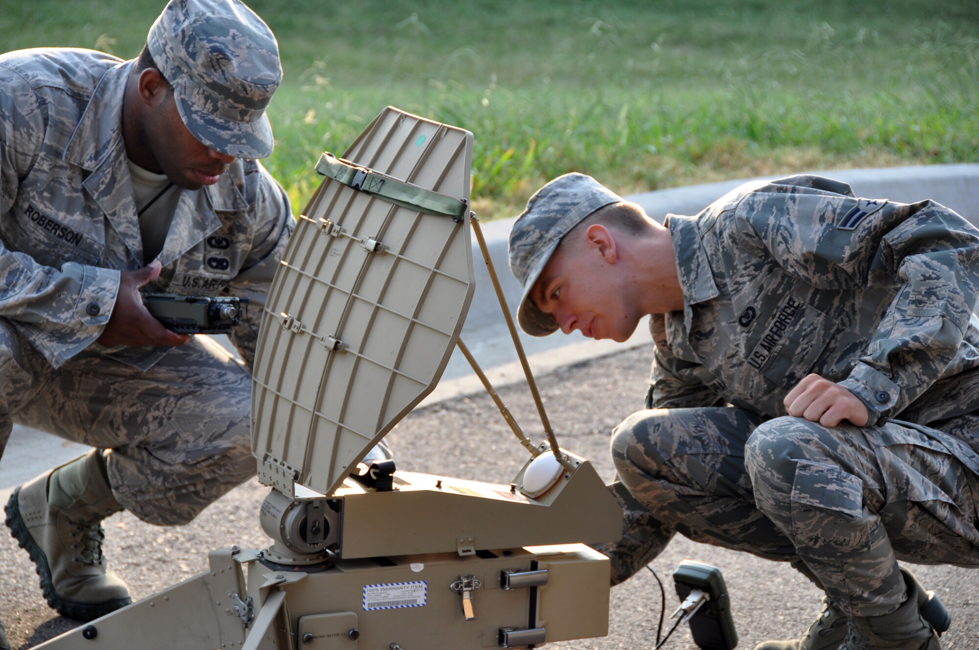 Airman 1st Class Christopher Capraro, 137th Air Refueling Wing Command Post, Oklahoma Air National Guard and Staff Sgt. Taream Roberson, 507th ARW Command Post set up Anti-Jam communication equipment while Airman Natalie Gates, 507th ARW CP runs the checklist in support of the training here Sept. 13.  The combined command post team spent a week training to use the mobile communication equipment which provides worldwide, anti-jam, secure voice capabilities for the command and control team.  (U.S. Air Force Photo/Maj. Jon Quinlan)  