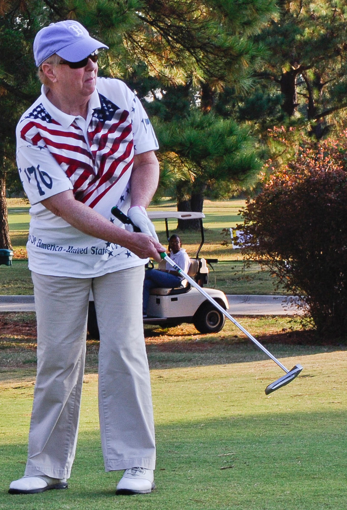 Joyce Richmond, mother of Chief Master Sgt. Denise "Mik" Mikolajczyk, putts a golf ball during the 5th annual Langley Chief's Group "Chief Mik" Golf Tournament at Langley Air Force Base, Va., Oct. 4, 2013. The tournament is held in honor of the late Chief Mik. (U.S. Air Force photo by Senior Airman Connor Estes/Released)
