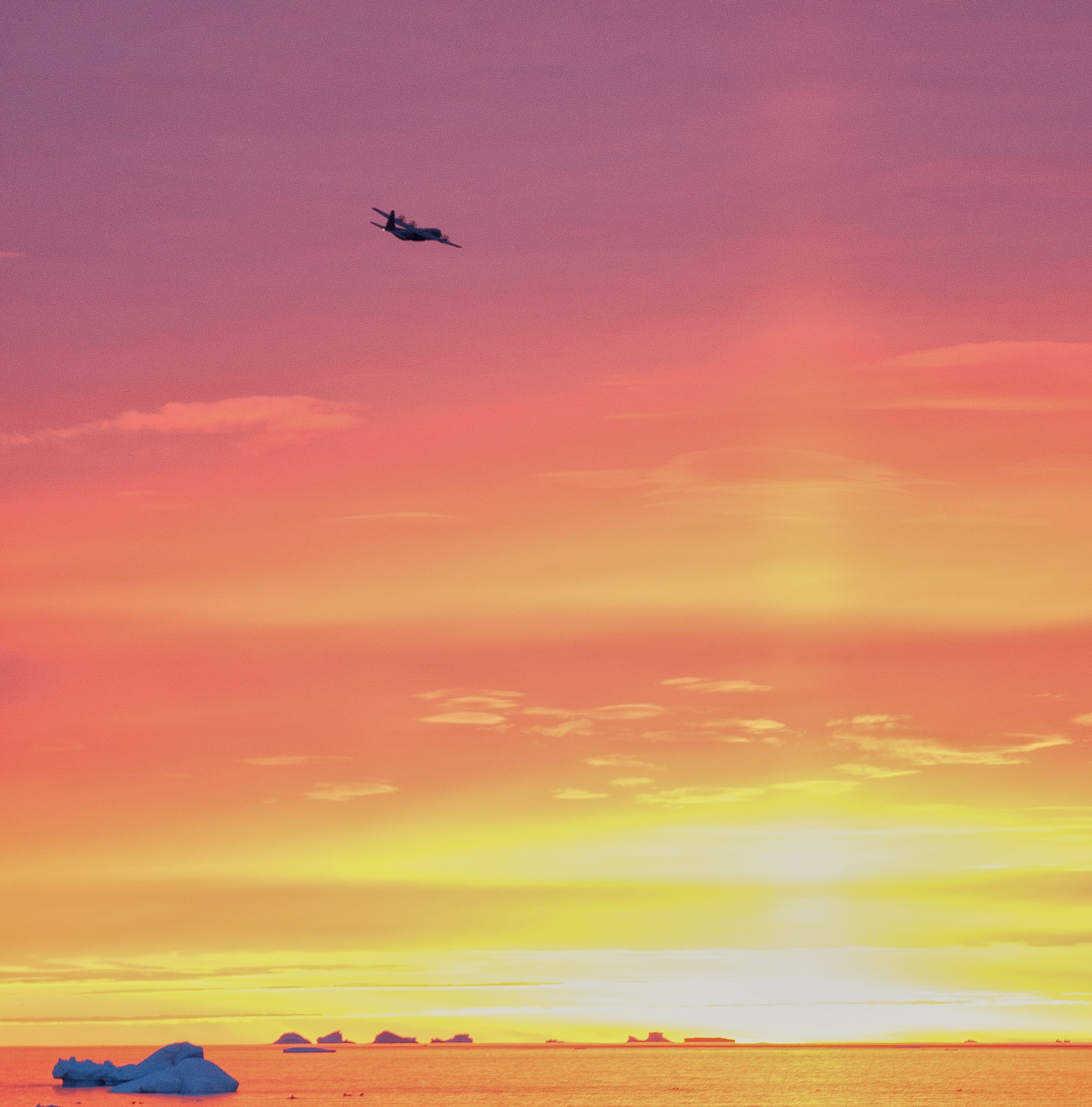 THULE AIR BASE, Greenland -- A Royal Canadian Air Force C-130J takes off at dusk over North Star Bay during Operation BOXTOP II 2013. Three C-130s flew 24-hour operations to deliver vital supplies and fuel to remote arctic outposts in northern Canada. (U.S. Air Force photo/Tech. Sgt. Jeffrey Mikell)