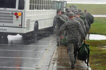 U.S. Air Force Airmen board a bus after processing a deployment line during Operational Readiness Exercise (ORE) CORONET WARRIOR 13-04 at Seymour Johnson Air Force Base, N.C., Oct. 7, 2013.  The ORE ensures 4th Fighter Wing Airmen maintain their readiness to support overseas contingencies by testing their mobility effectiveness.  (U.S. Air Force photo by Airman 1st Class Brittain Crolley)