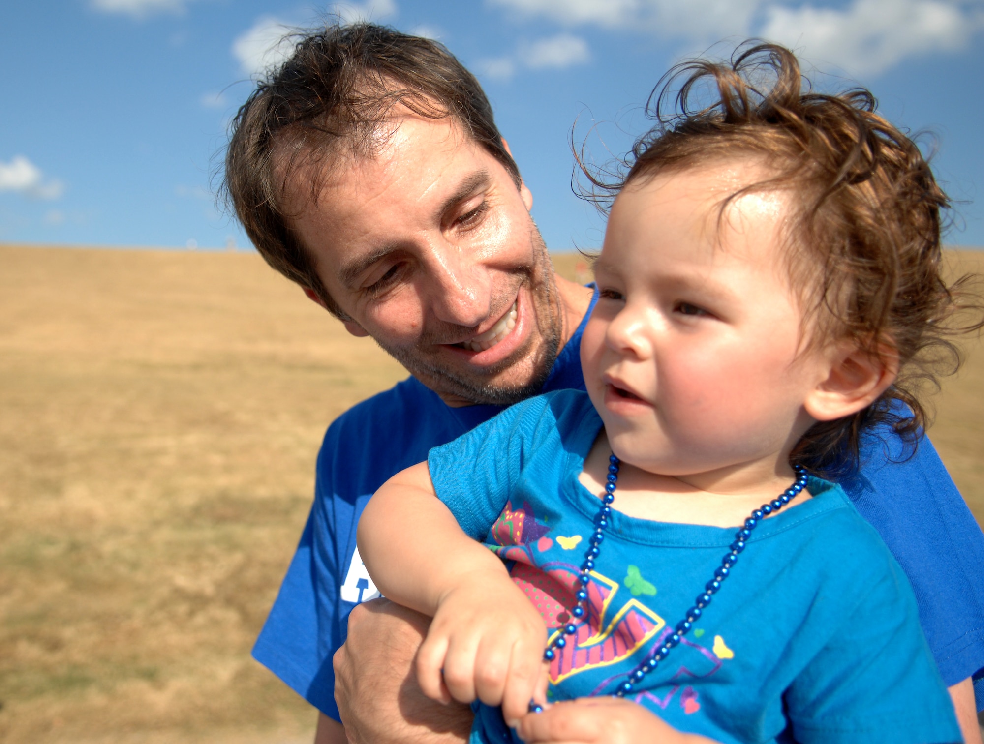 Jim Taccogno, a Joint Base Langley-Eustis spouse who suffers from Ulcerative Colitis, carries his 20-month-old daughter, Jonsie, during the “Take Steps for Crohn’s & Colitis Walk,” which took place at Mount Trashmore, in Virginia Beach, Va., Oct. 6, 2013. Jonsie, Jim, and his wife U.S. Air Force Capt. Charee Taccogno, right, 633rd Medical Group family health clinic registered nurse, were part of a team from Langley Air Force Base that came to support the event. (U.S. Air Force photo by Staff Sgt. Jarad A. Denton/Released) 
