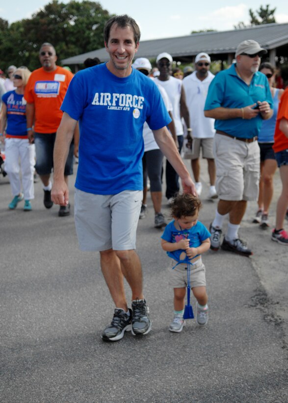 During the “Take Steps for Crohn’s & Colitis Walk,” which took place at Mount Trashmore, in Virginia Beach, Va., Oct. 6, 2013, Jim Taccogno, a Joint Base Langley-Eustis spouse who suffers from Ulcerative Colitis, walks with his 20-month-old daughter, Jonsie. Jim was first diagnosed with Colitis a decade ago, and has been living in pain with the disease ever since. (U.S. Air Force photo by Staff Sgt. Jarad A. Denton/Released)