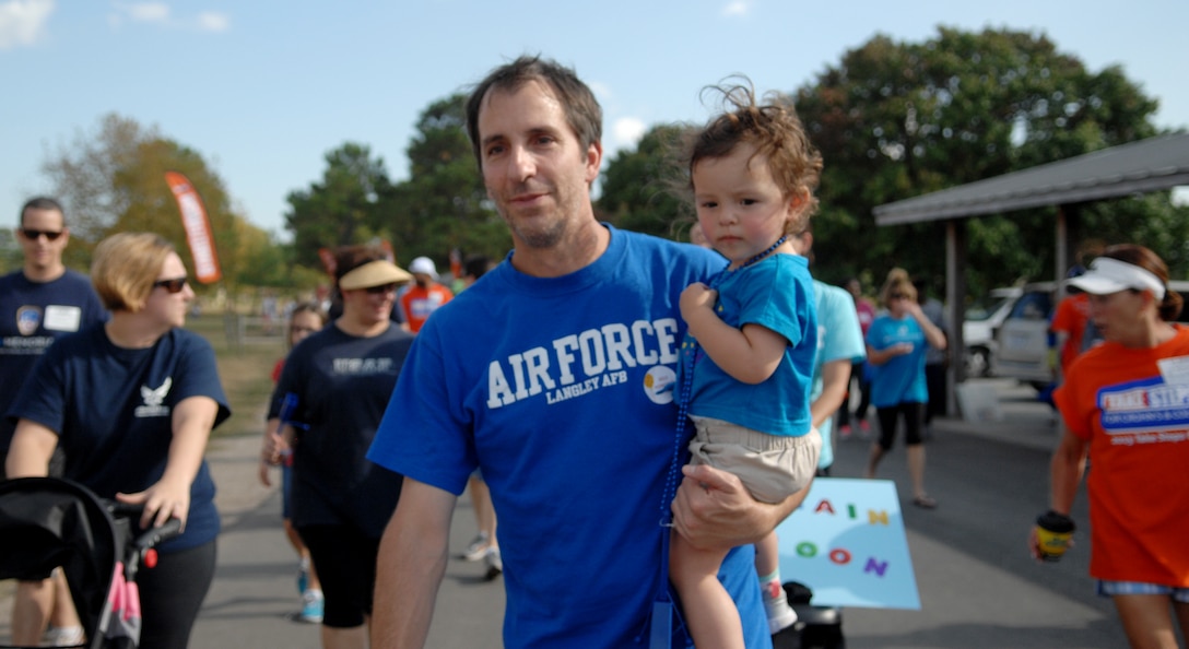 Jim Taccogno, a Joint Base Langley-Eustis spouse who suffers from Ulcerative Colitis, carries his 20-month-old daughter, Jonsie, during the “Take Steps for Crohn’s & Colitis Walk,” which took place at Mount Trashmore, in Virginia Beach, Va., Oct. 6, 2013. Both Crohn’s disease and Ulcerative Colitis affect roughly one in every 200 Americans. (U.S. Air Force photo by Staff Sgt. Jarad A. Denton/Released)