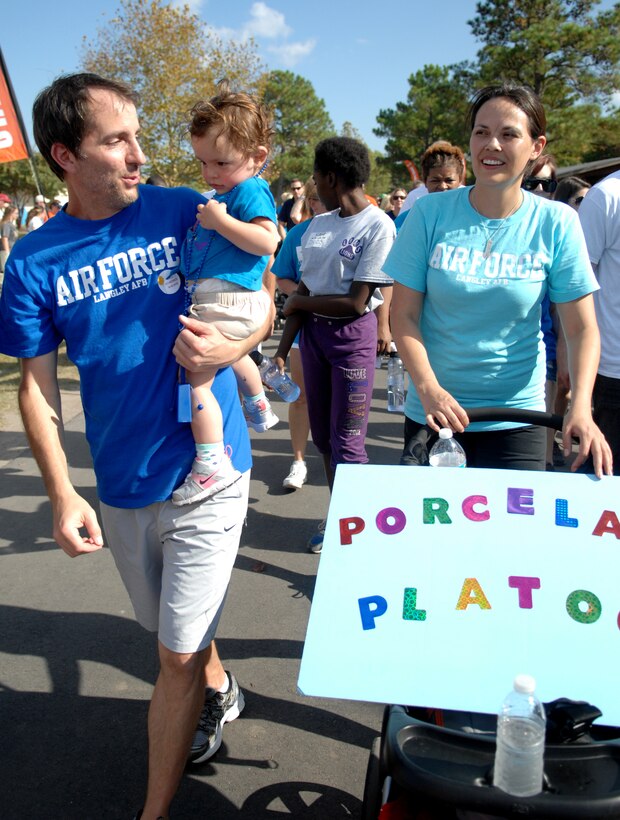 Jim Taccogno, left, an Ulcerative Colitis survivor and husband to U.S. Air Force Capt. Charee Taccogno, right, 633rd Medical Group family health clinic registered nurse, walks while carrying 20-month-old Jonsie Taccogno, during the “Take Steps for Crohn’s & Colitis Walk,” at Mount Trashmore, in Virginia Beach, Va., Oct. 6, 2013. The walk was sponsored by the Crohn’s and Colitis Foundation of America – a non-profit, volunteer-driven organization committed to finding cures for both diseases. (U.S. Air Force photo by Staff Sgt. Jarad A. Denton/Released)