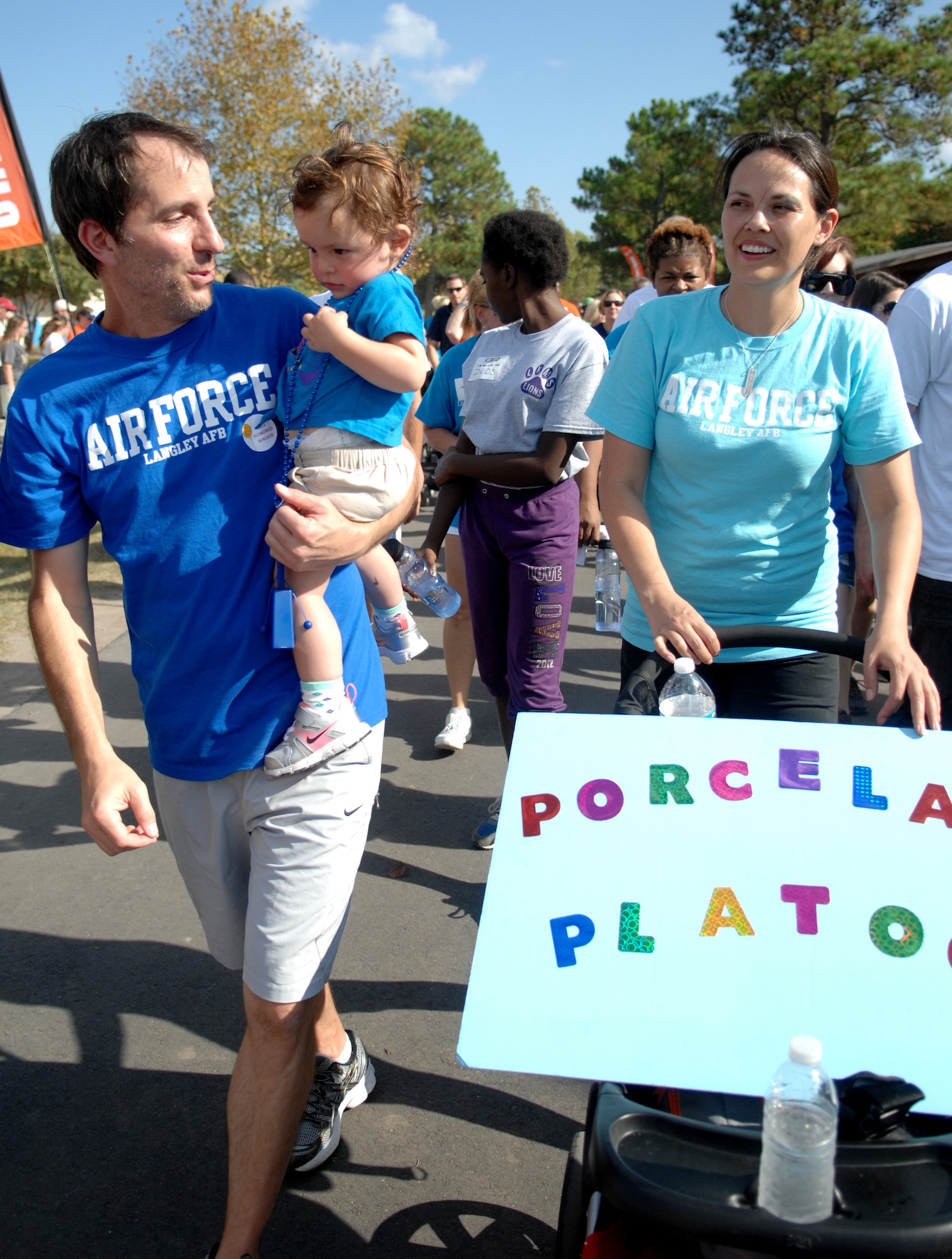 Jim Taccogno, left, an Ulcerative Colitis survivor and husband to U.S. Air Force Capt. Charee Taccogno, right, 633rd Medical Group family health clinic registered nurse, walks while carrying 20-month-old Jonsie Taccogno, during the “Take Steps for Crohn’s & Colitis Walk,” at Mount Trashmore, in Virginia Beach, Va., Oct. 6, 2013. The walk was sponsored by the Crohn’s and Colitis Foundation of America – a non-profit, volunteer-driven organization committed to finding cures for both diseases. (U.S. Air Force photo by Staff Sgt. Jarad A. Denton/Released)