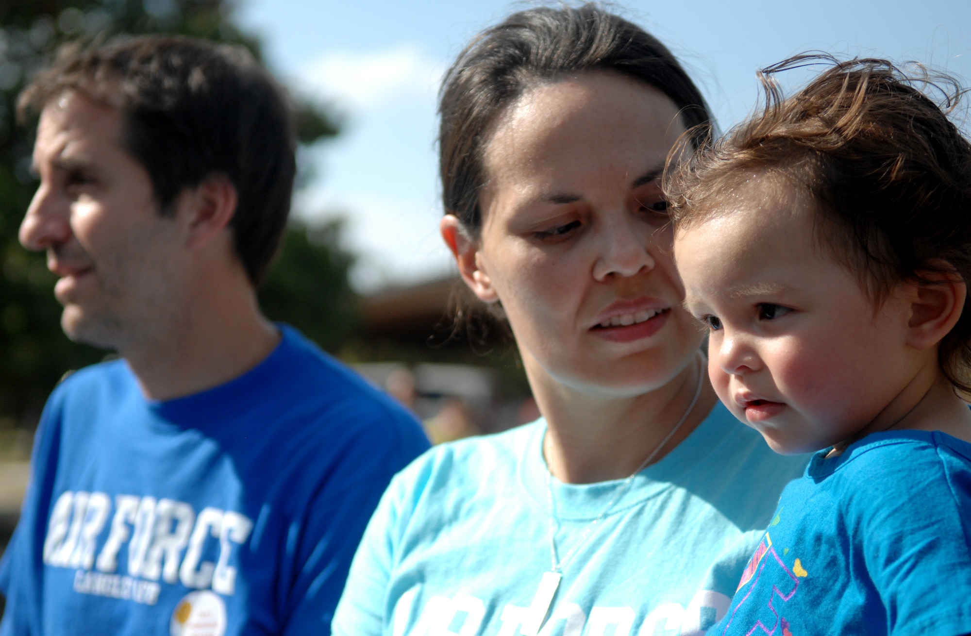 U.S. Air Force Capt. Charee Taccogno, center, 633rd Medical Group family health clinic registered nurse, holds her 20-month-old daughter, Jonsie, while her husband, Jim, listens to stories of survival during the “Take Steps for Crohn’s & Colitis Walk,” at Mout Trashmore, in Virginia Beach, Va., Oct. 6, 2013. Jim was diagnosed with Ulcerative Colitis nearly a decade ago, and has been living with the incurable disease since. (U.S. Air Force photo by Staff Sgt. Jarad A. Denton/Released)