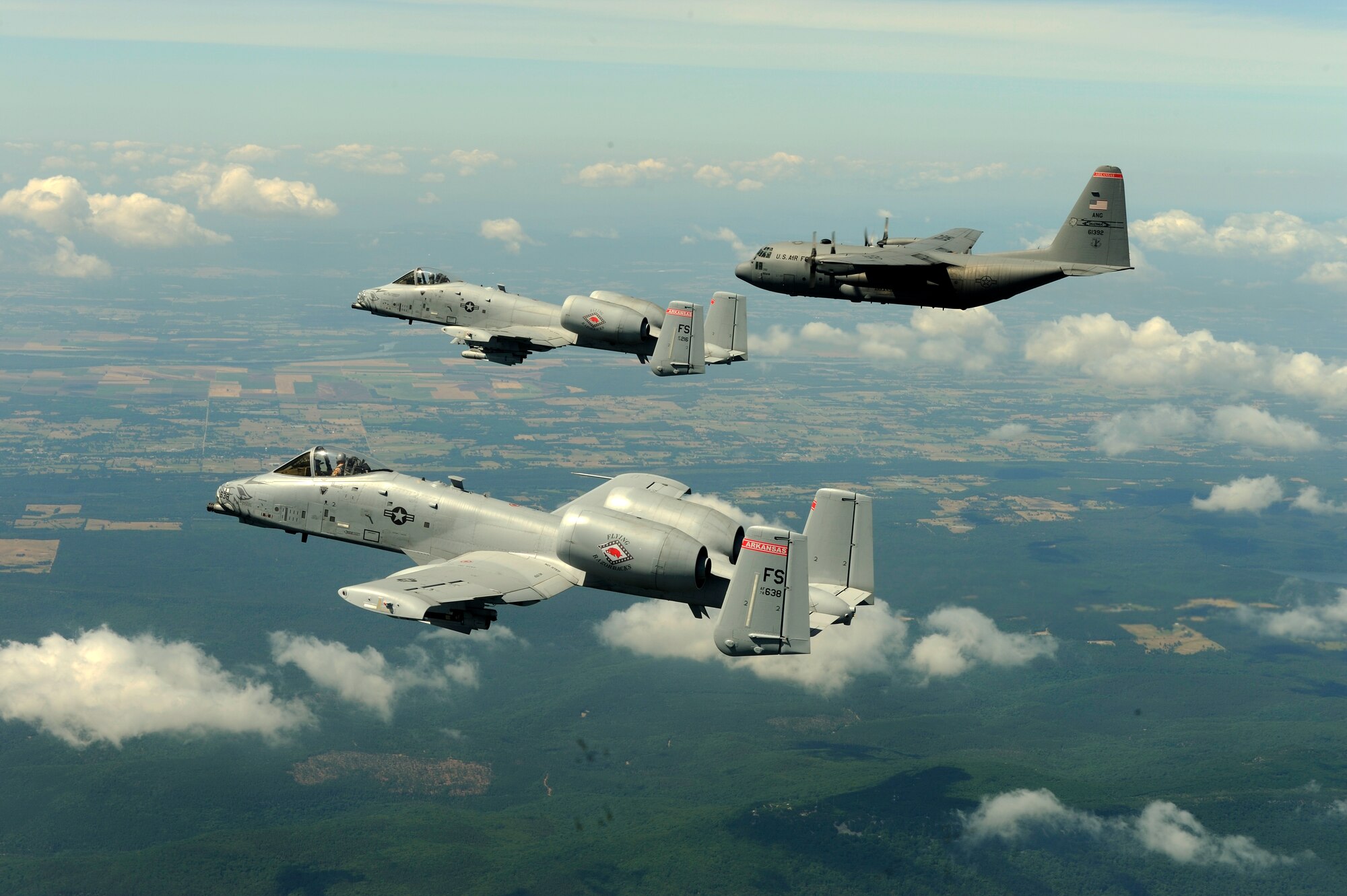 A two-ship of A-10C Thunderbolt II “Warthogs” from the 188th Fighter Wing flies alongside a C-130 Hercules from the 189th Airlift Wing during an exercise with members of the 75th Ranger Regiment near the 188th’s Detachment 1 Razorback Range. Both wings are from the Arkansas Air National Guard. The 188th is based in Fort Smith while the 189th resides on Little Rock Air Force Base. (U.S. Air Force photo by Master Sgt. Ben Bloker/ 2nd Combat Camera Squadron)