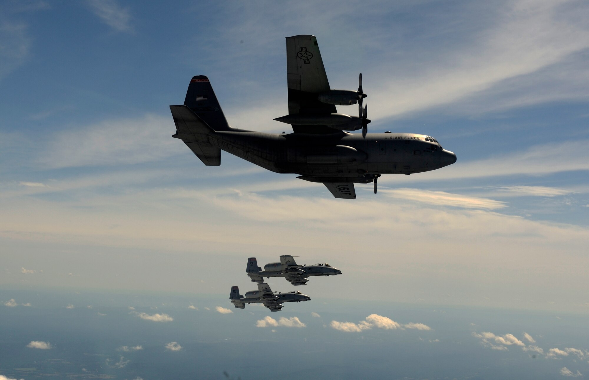 A two-ship of A-10C Thunderbolt II “Warthogs” from the 188th Fighter Wing flies alongside a C-130 Hercules from the 189th Airlift Wing during an exercise with members of the 75th Ranger Regiment near the 188th’s Detachment 1 Razorback Range. Both wings are from the Arkansas Air National Guard. The 188th is based in Fort Smith while the 189th resides on Little Rock Air Force Base. (U.S. Air Force photo by Master Sgt. Ben Bloker/ 2nd Combat Camera Squadron)