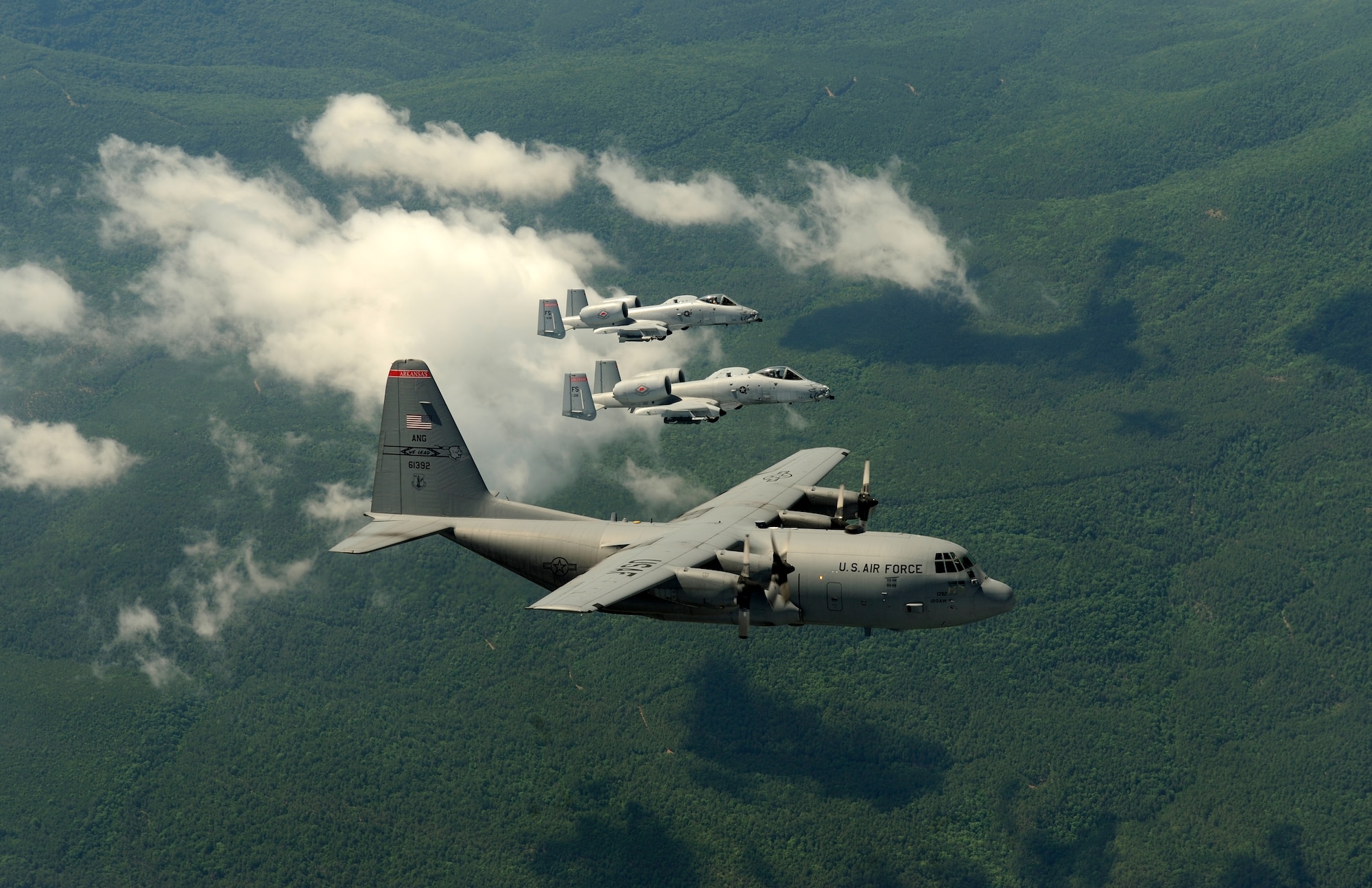A two-ship of A-10C Thunderbolt II “Warthogs” from the 188th Fighter Wing flies alongside a C-130 Hercules from the 189th Airlift Wing during an exercise with members of the 75th Ranger Regiment near the 188th’s Detachment 1 Razorback Range. Both wings are from the Arkansas Air National Guard. The 188th is based in Fort Smith while the 189th resides on Little Rock Air Force Base. (U.S. Air Force photo by Master Sgt. Ben Bloker/ 2nd Combat Camera Squadron)