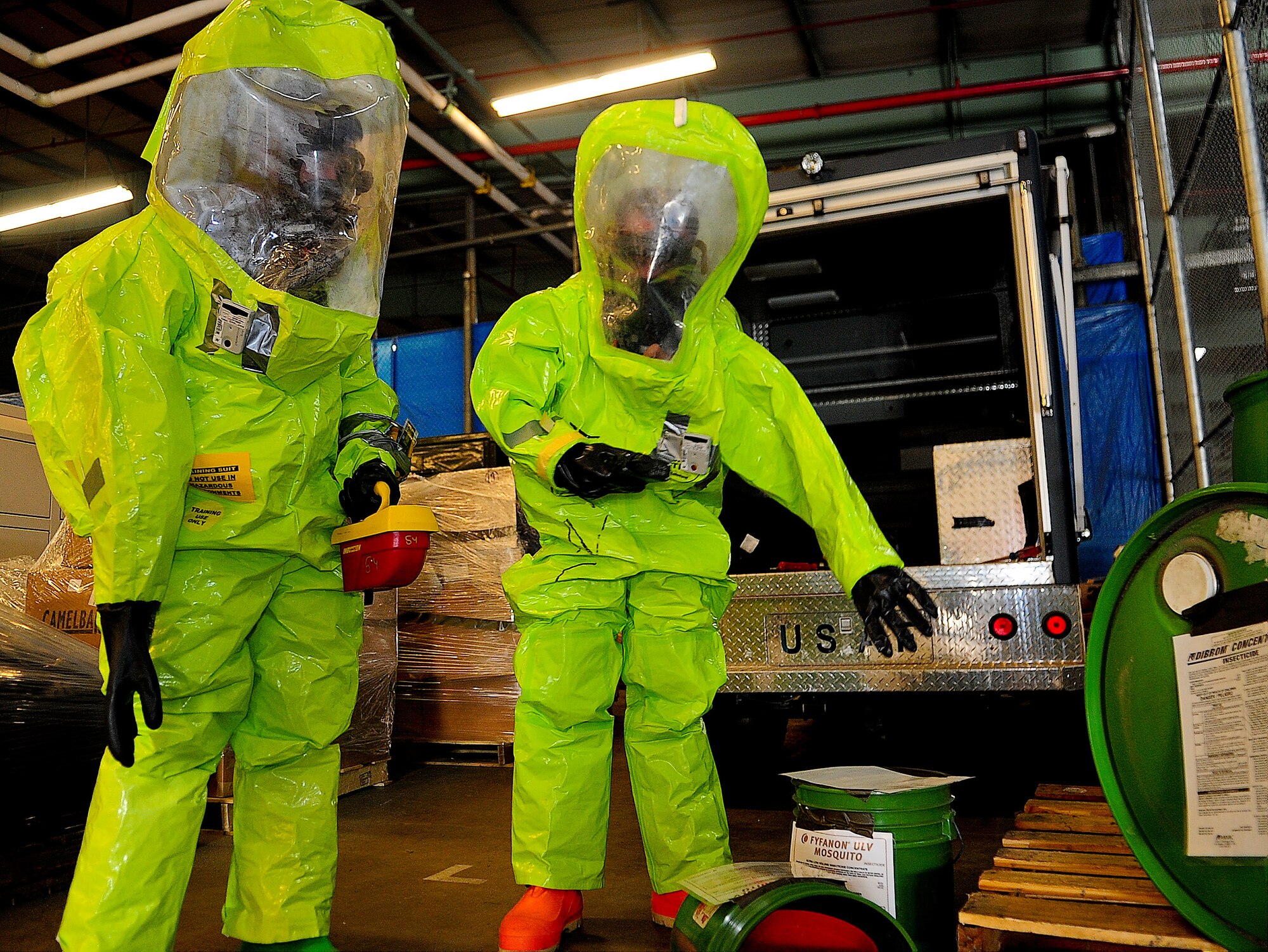 Senior Airman Joseph Davis, 436th Civil Engineer Squadron emergency management technician, and Airman 1st Class Alexander Delfs, 436th Aero-Medical Squadron bioenvironmental engineering technician, radio in an unknown chemical spill they found during a medial readiness exercise Oct. 2, 2013, at Dover Air Force Base, Del. The team’s job was to survey the scene for any vapors, radiation or chemical agents. (U.S. Air Force photo/Airman 1st Class Ashlin Federick)
