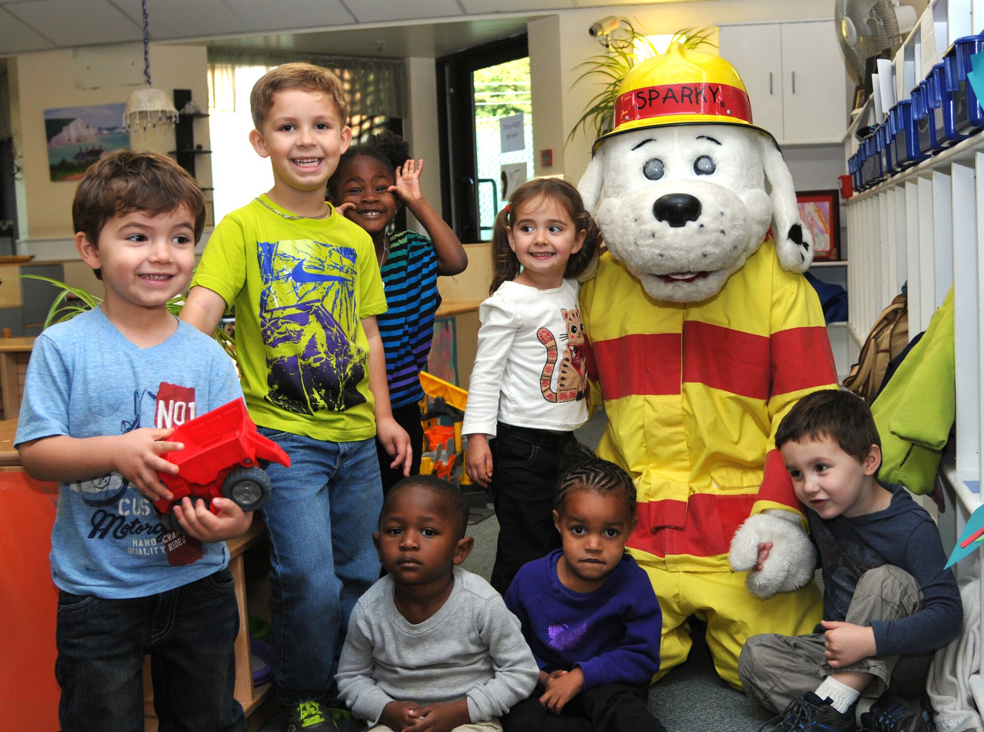 Sparky the Fire Dog, 100th Civil Engineer Squadron Fire Department mascot, visits children Oct. 7, 2013, at the Child Development Center on RAF Mildenhall, England. Sparky visited the CDC as part of Fire Prevention Week. This year, Fire Prevention Week is from Oct. 6 to 10, 2013.  (U.S. Air Force photo by Airman 1st Class Kelsey Waters/Released)