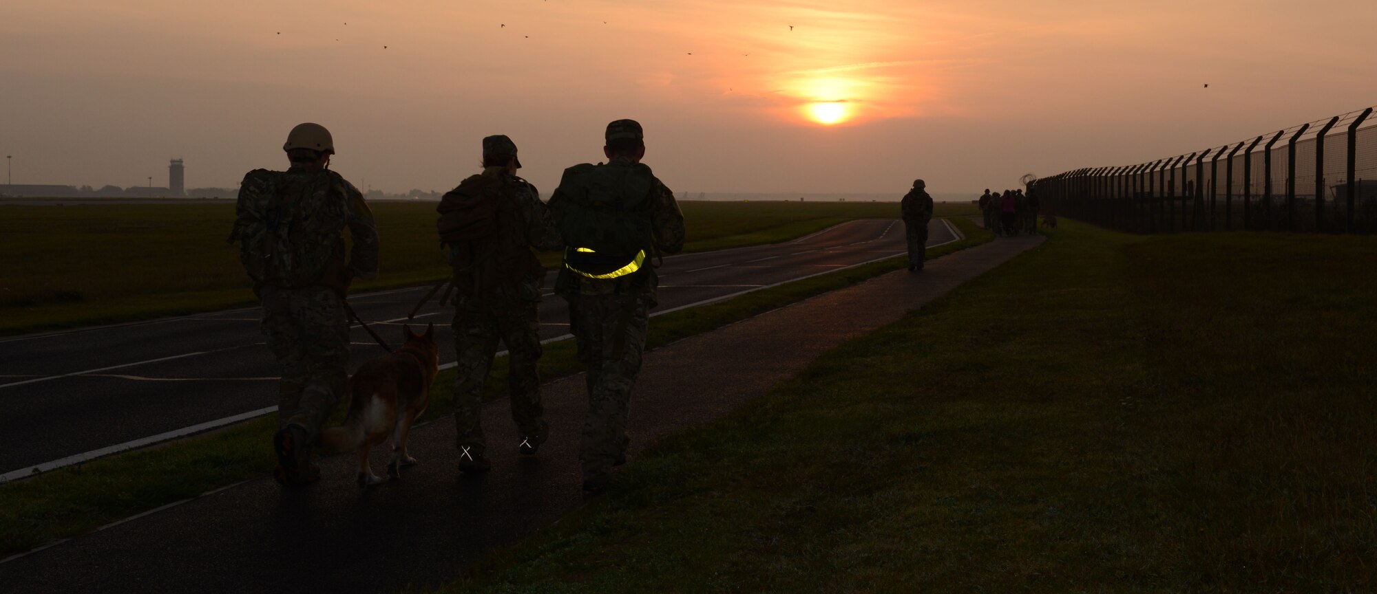 Team Mildenhall Airmen participate in a 5km ruck march called the Mogadishu Mile Oct. 3, 2013, at RAF Mildenhall, England. The original Mogadishu Mile was a route run by special operations forces from a helicopter crash to a rally point while under fire. The Team Mildenhall 5km ruck march honored the American lives lost in Mogadishu, Somalia, Oct. 4, 1993. (U.S. Air Force photo by Airman 1st Class Preston Webb/Released)