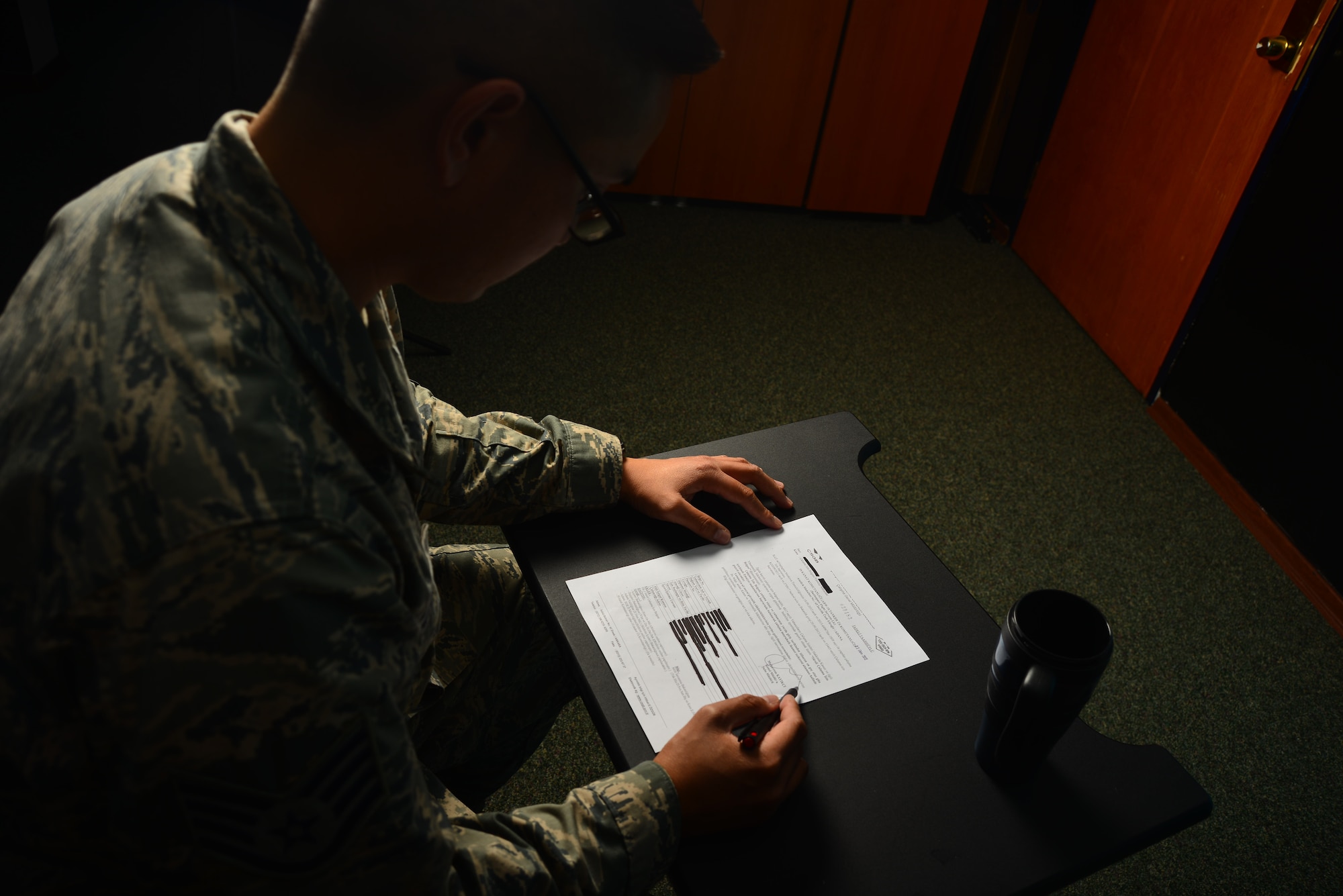 An Airman fills out a work permit form Oct. 8, 2013, at Incirlik Air Base, Turkey. In order for service members, federal employees or their family members to work off-base they must obtain a work permit authorized by Turkey’s Ministry of Labor or face penalties ranging from fines to deportation. (U.S. Air Force photo by Staff Sgt. Eric Summers Jr./Released)