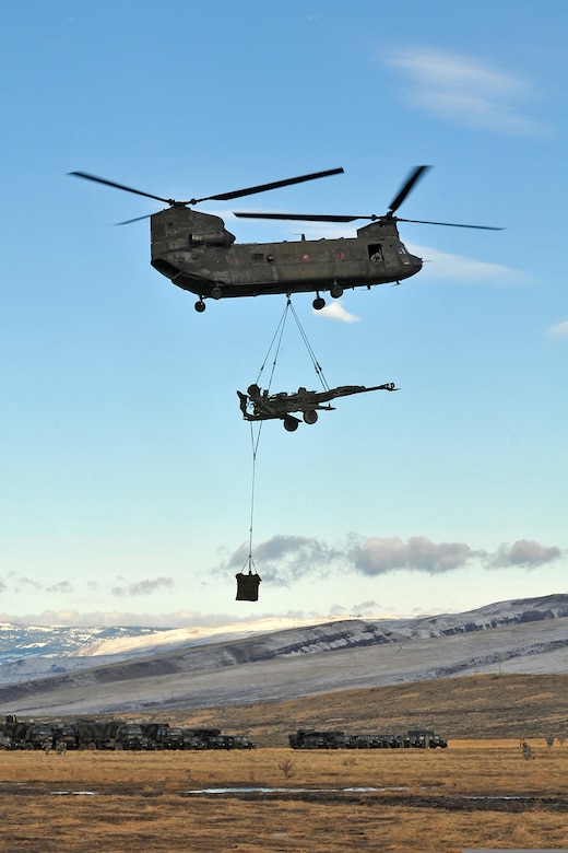 Members of a CH-47 Chinook helicopter, with 1st Battalion, 214th Aviation Regiment, lift an M777, 155 mm howitzer, assigned to 2nd Battalion, 12th Field Artillery Regiment, 4th Stryker Brigade Combat Team, 2nd Infantry Division in an artillery raid supporting the brigade offensive operations during Exercise Raider Focus at Yakima Training Center, Wash., Jan. 30, 2012. Although CH-47s are not combat helicopters, they do have hardpoints to mount three gunners and Kevlar plates for additional protection. (U.S. Army photo by Spc. Reese Von Rogatsz/Released) 