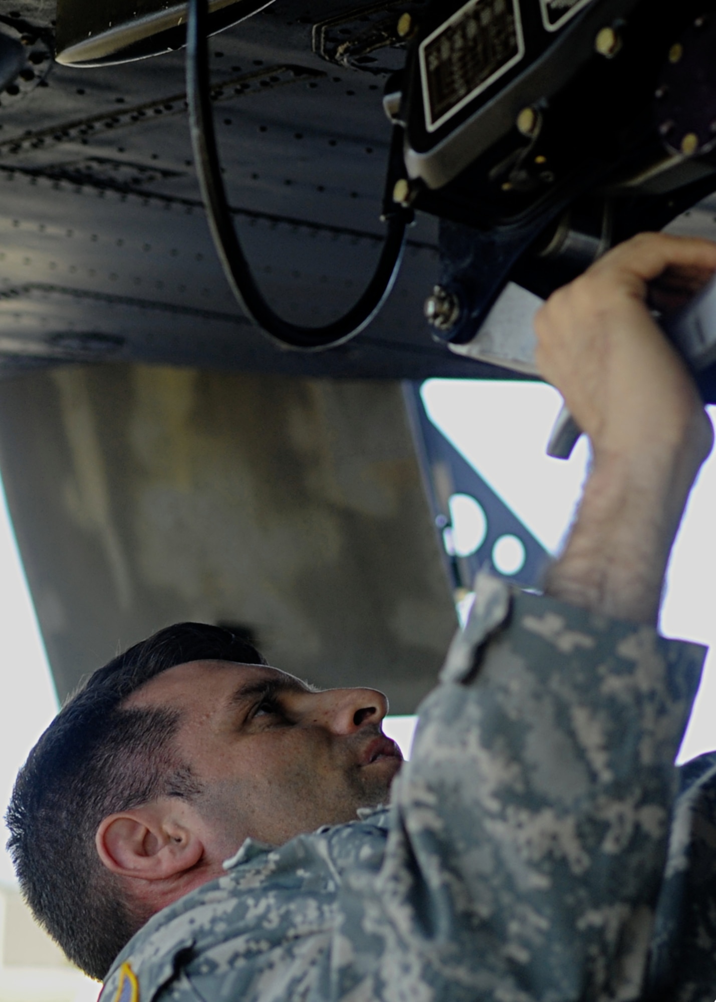U.S. Army Sgt. 1st Class Jason Loveday, 5th Battalion, 159th Aviation Regiment, D Company platoon sergeant, inspects a Boeing CH-47 Chinook helicopter after maintenance at Fort Eustis, Va., Oct. 3, 2013. CH-47s are mainly used to transport cargo internally and externally with the use of sling loads. (U.S. Air Force photos by Airman 1st Class Austin Harvill/Released)