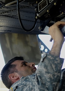 U.S. Army Sgt. 1st Class Jason Loveday, 5th Battalion, 159th Aviation Regiment, D Company platoon sergeant, inspects a Boeing CH-47 Chinook helicopter after maintenance at Fort Eustis, Va., Oct. 3, 2013. CH-47s are mainly used to transport cargo internally and externally with the use of sling loads. (U.S. Air Force photos by Airman 1st Class Austin Harvill/Released)