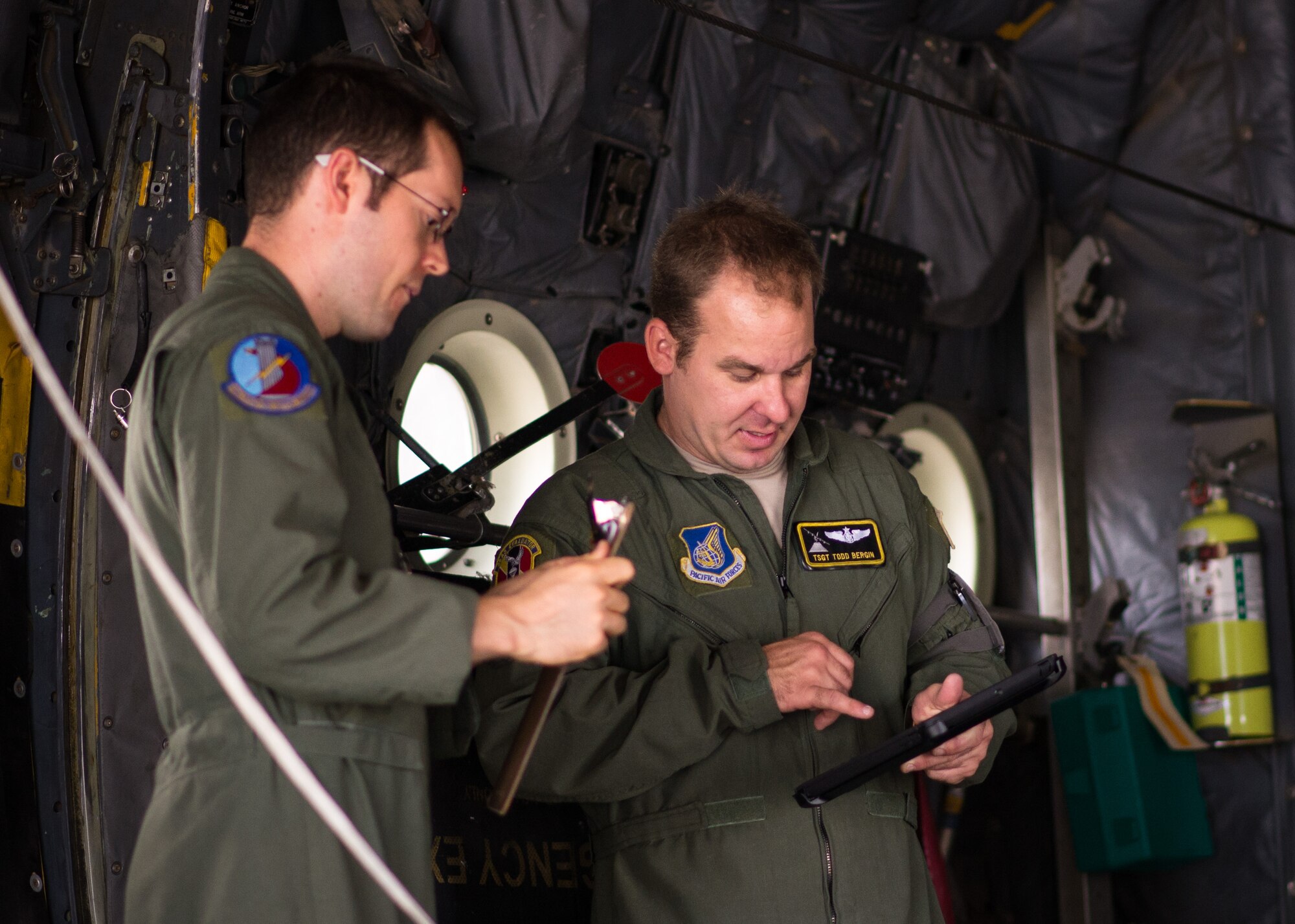 Yokota loadmasters check over instructions prior to a training flight as part of Readiness Week at Yokota Air Base, Japan, Oct. 8, 2013. Loadmasters rely on the careful work of maintainers and logisticians to make sure their aircraft can perform the mission safely and on time. (U.S. Air Force photo by Captain Raymond Geoffroy/Released)