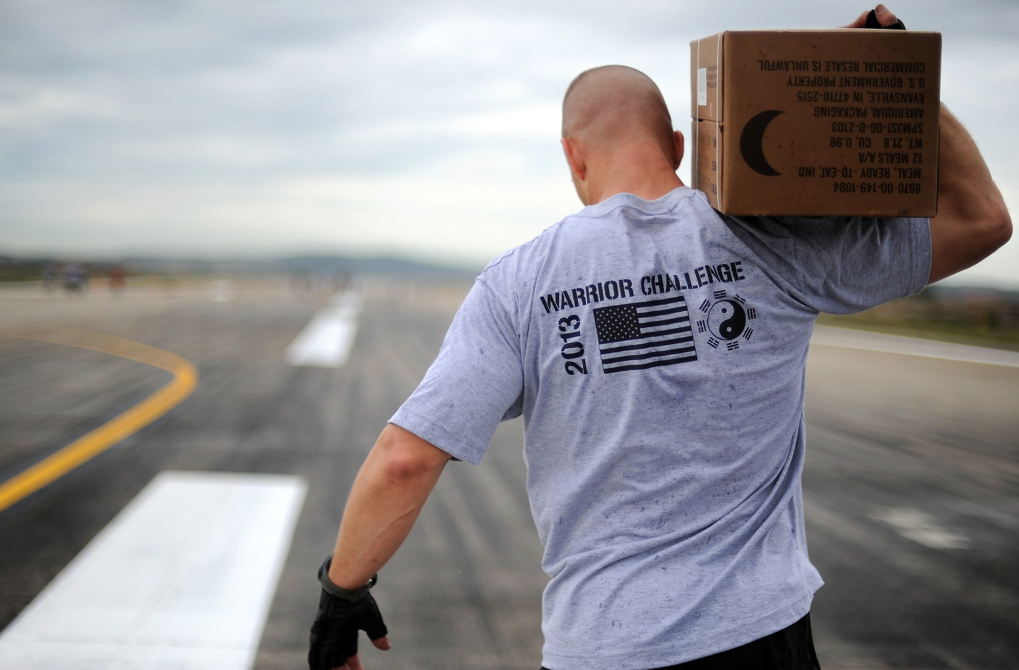 Col. Brook Leonard, 51st Fighter Wing commander, competes in the Runway Fitness challenge during the Osan Warrior Challenge on the flight line at Osan Air Base, Republic of Korea, Oct. 7, 2013. After the runway challenge Team Osan ran in a 1.5-mile formation run. The events were held to promote physical fitness, morale and camaraderie between all military personnel at Osan. (U.S. Air Force photo/Staff Sgt. Sara Csurilla)
