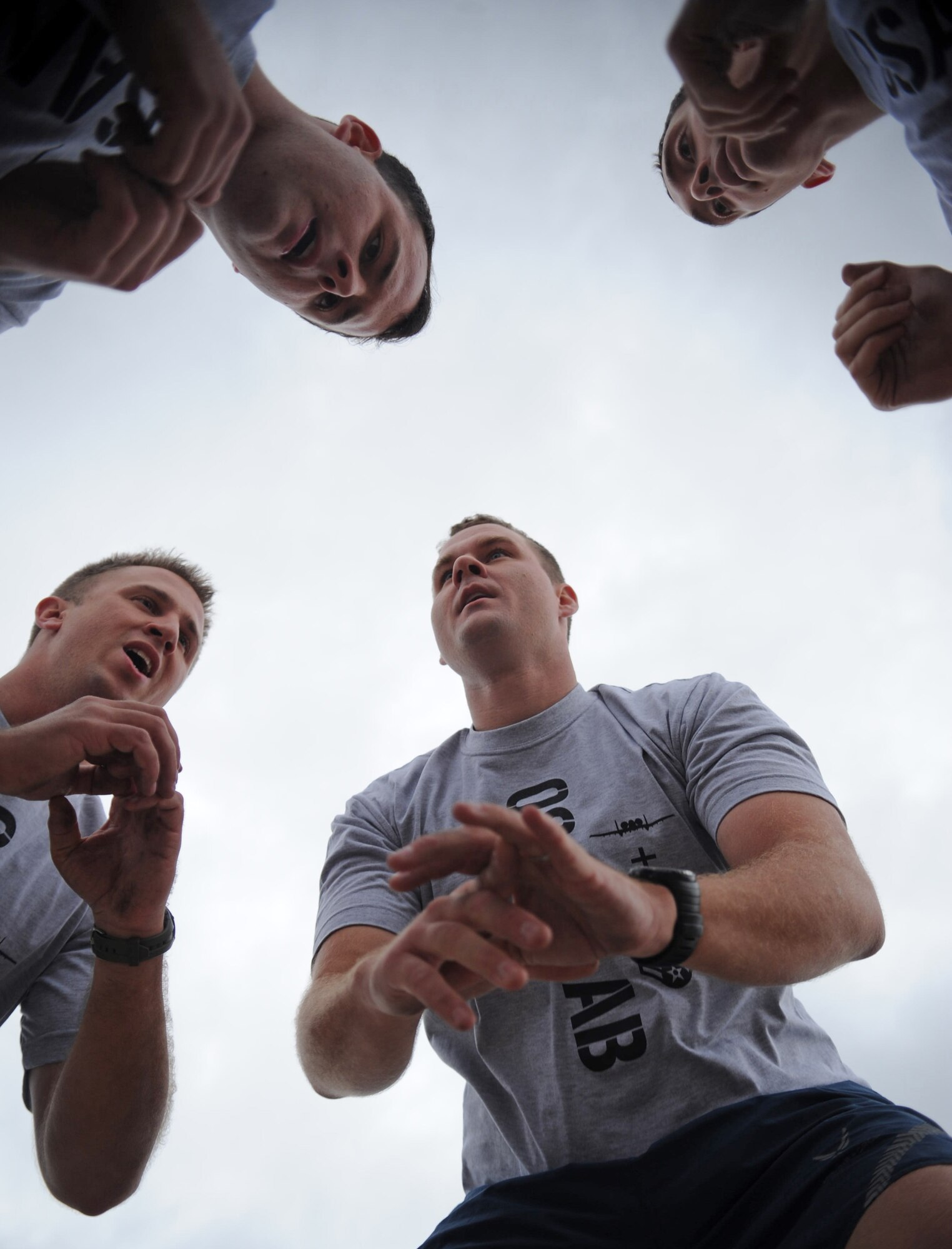 A team squats together as part of the Runway Fitness Challenge on the flight line at Osan Air Base, Republic of Korea, Oct. 7, 2013. The burpee broad jumps were the last exercise of the Runway Fitness Challenge, which was part of the Osan Warrior Challenge. (U.S. Air Force photo/Staff Sgt. Sara Csurilla)