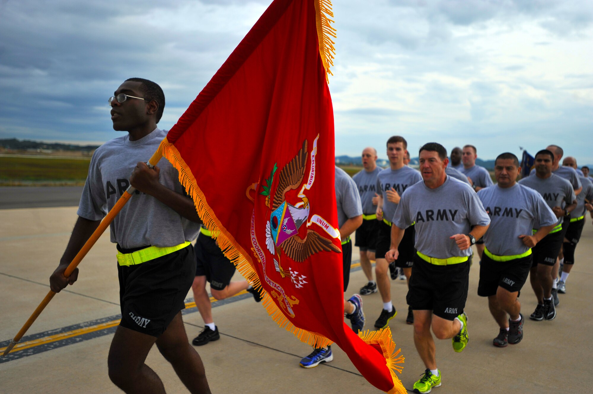 Members of the 3rd Battlefield Coordination Detachment run in formation during a base-wide 1.5 mile run on the flight line at Osan Air Base, Republic of Korea, Oct. 7, 2013. The U.S. Army’s 3rd BCD, along with the 35th Air Defense Artillery Brigade, participated in the 1.5 mile run, making the run truly a “Team Osan” event. (U.S. Air Force photo/Senior Airman Siuta B. Ika)