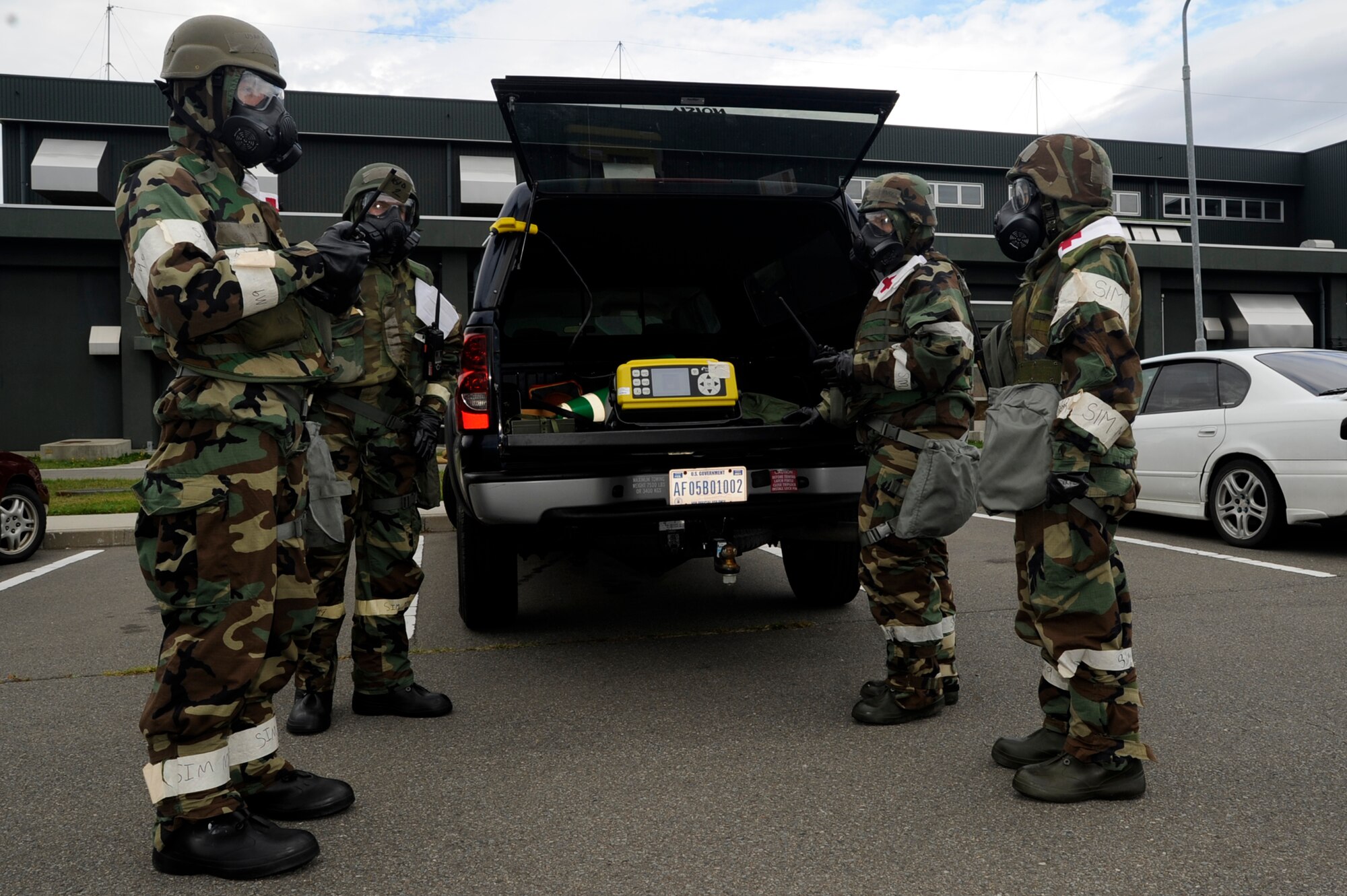 Airmen from the 35th Aerospace Medical Squadron Bioenvironmental Engineering flight test the air for chemical contamination during an Operational Readiness Exercise at Misawa Air Base, Japan, Oct. 8, 2013. The information collected by the flight is relayed to the emergency operations center for risk assessment to determine when Airmen should remove mission orientation protective posture gear during after simulated attacks. (U.S. Air Force photo by Staff Sgt. Tong Duong)
