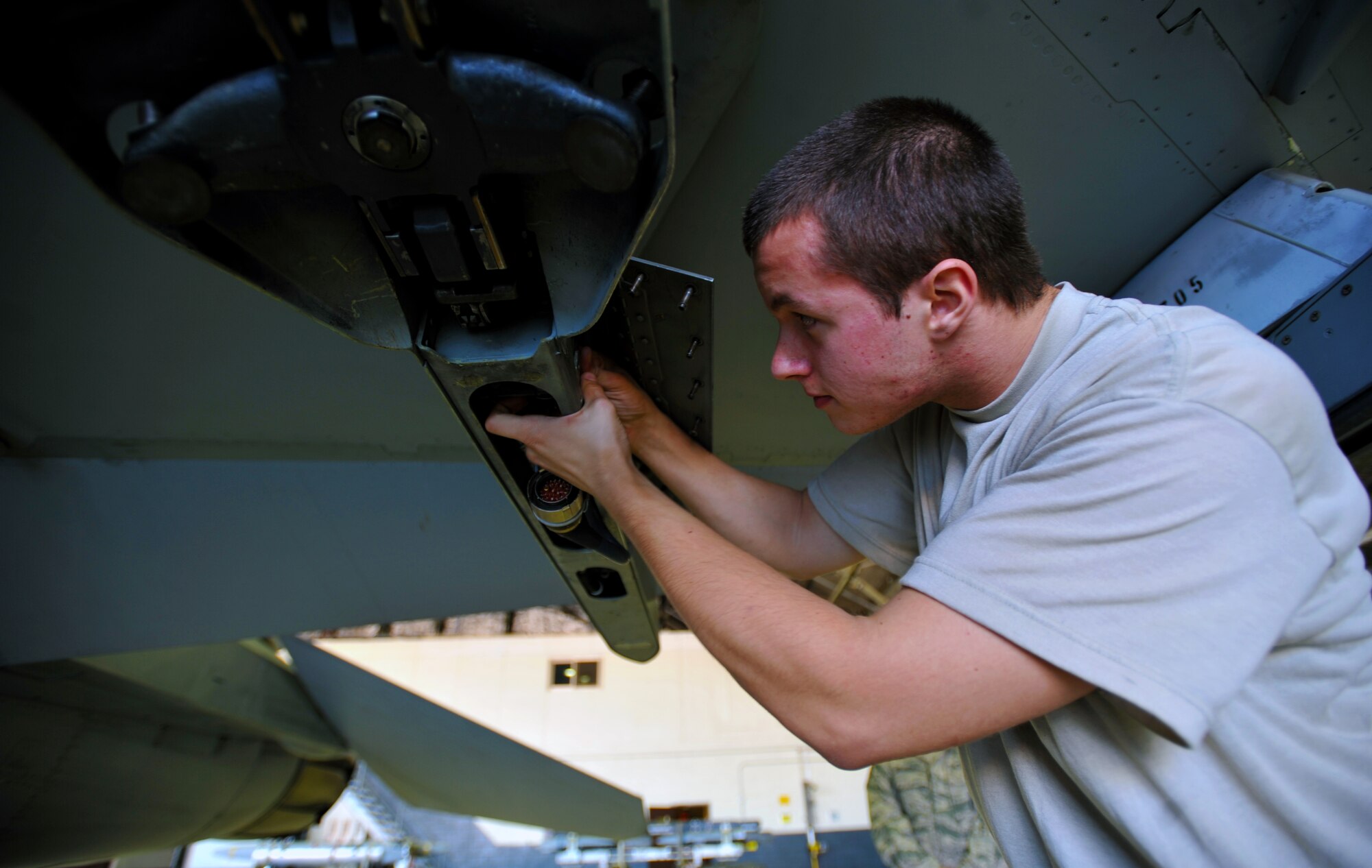 Senior Airman Jordon Leach, 36th Aircraft Maintenance Unit weapons load crew member, works on a weapons platform on an F-16 Fighting Falcon during a quarterly weapons load crew competition at Osan Air Base, Republic of Korea, Oct. 4, 2013. Load crew competitions are held to give weapons personnel the opportunity to display their war-fighting skills and to unveil the best weapons load crew for a particular quarter during the year. (U.S. Air Force photo/Senior Airman Siuta B. Ika)