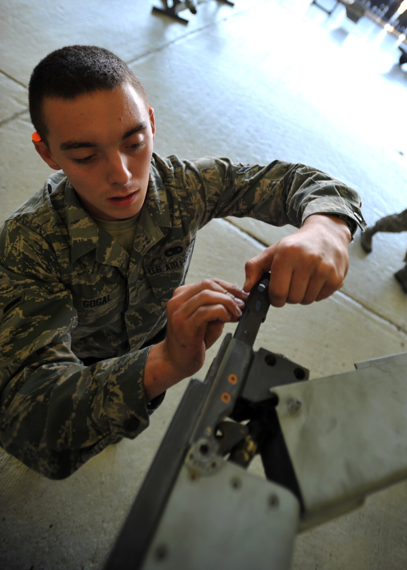 Airman Matthew Gogal, 25th Aircraft Maintenance Unit weapons load crew member, prepares an A-10 Thunderbolt to be loaded with a munition during a quarterly weapons load crew competition at Osan Air Base, Republic of Korea, Oct. 4, 2013. In addition to the weapons loading, crews are also inspected on their dress and appearance, and given a written examination to determine the 51st Maintenance Group’s best weapons load crew of the quarter. (U.S. Air Force photo/Senior Airman Siuta B. Ika)