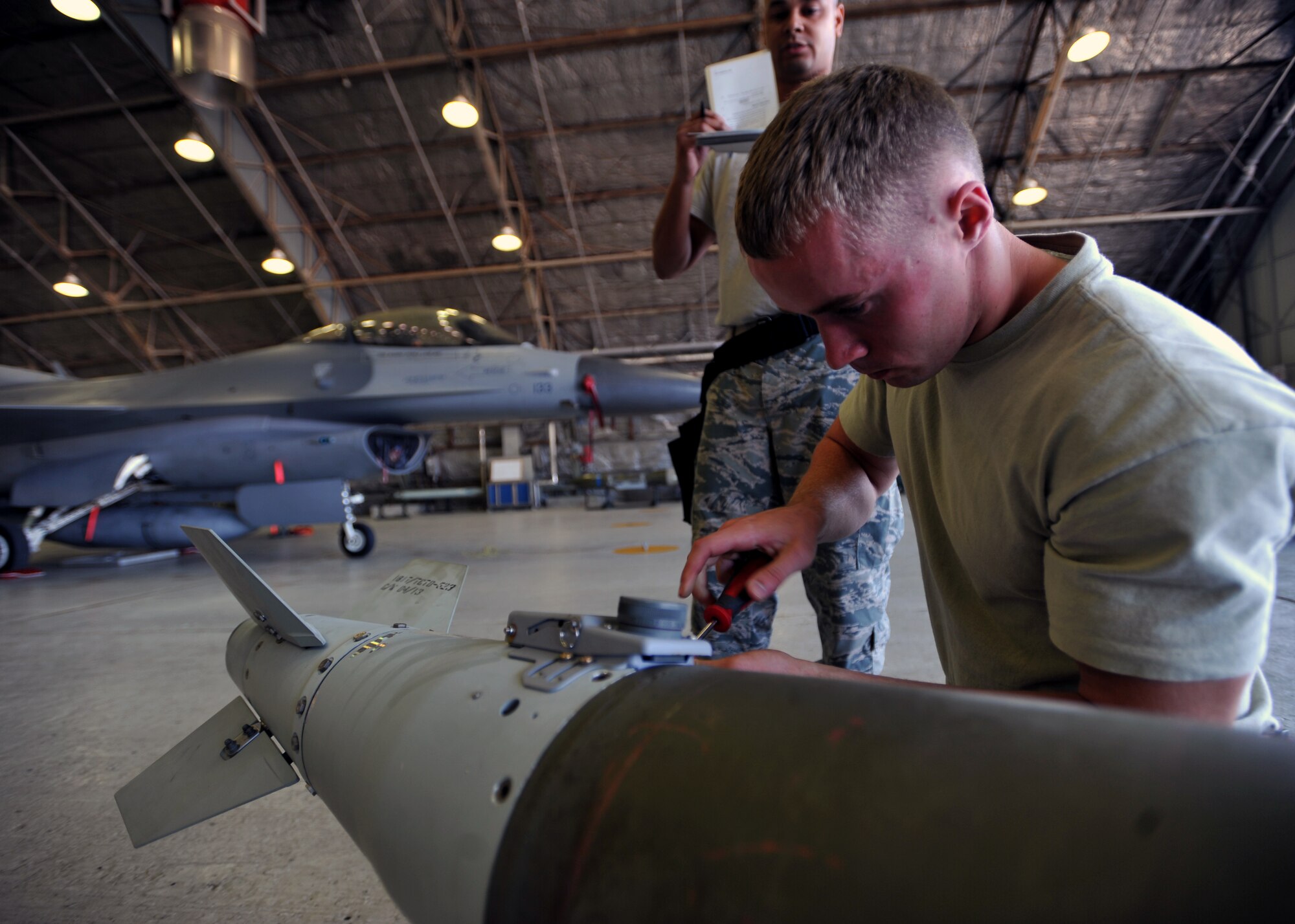 Senior Airman Dylan Haddock, 36th Aircraft Maintenance Unit weapons load crew member, prepares a munition to be loaded onto an F-16 Fighting Falcon during a quarterly weapons load crew competition at Osan Air Base, Republic of Korea, Oct. 4, 2013. Load crew competitions are held to give weapons personnel the opportunity to display their war-fighting skills and to unveil the best weapons load crew for a particular quarter during the year. (U.S. Air Force photo/Senior Airman Siuta B. Ika)