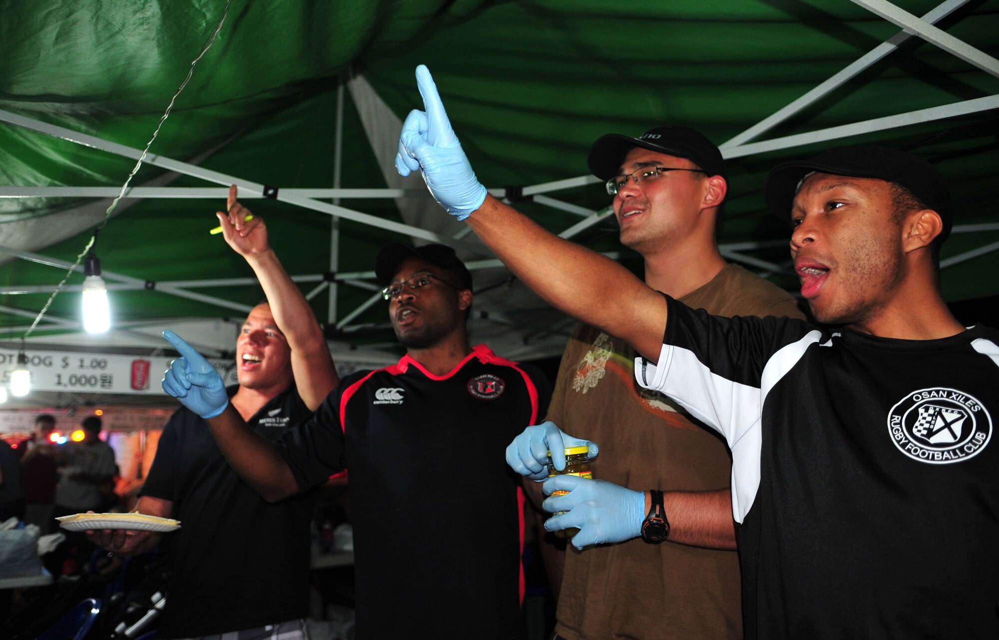 Members of the Osan rugby team encourage passersby to purchase tacos at their booth during the 10th Annual Korean-American Friendship Festival in the Songtan Entertainment District, Republic of Korea, Oct. 6, 2013. Hundreds of booths lined the streets in the Songtan area showcasing American, local and world cuisine. (U.S. Air Force photo/Airman 1st Class Ashley J. Thum) 