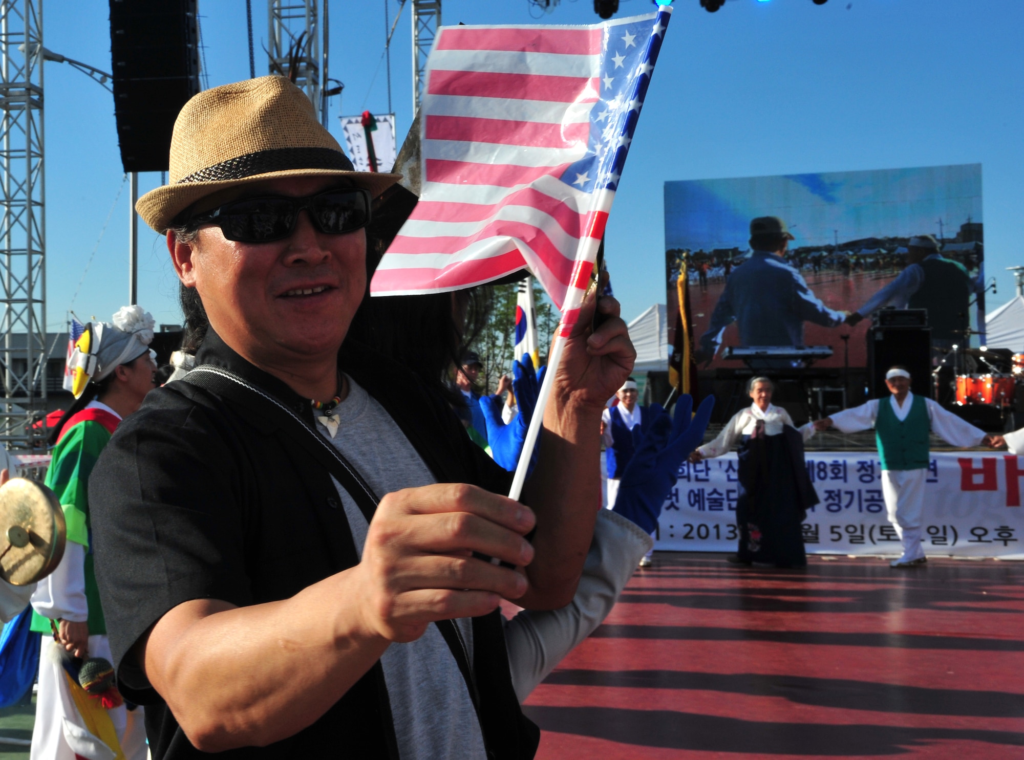 An audience member waves an American flag during a participation activity at the 10th Annual Korean-American Friendship Festival in the Songtan Entertainment District, Republic of Korea, Oct. 5, 2013. Those attending the festival were afforded a unique opportunity to experience unique aspects of one another’s culture in a fun and relaxed atmosphere. (U.S. Air Force photo/Airman 1st Class Ashley J. Thum)