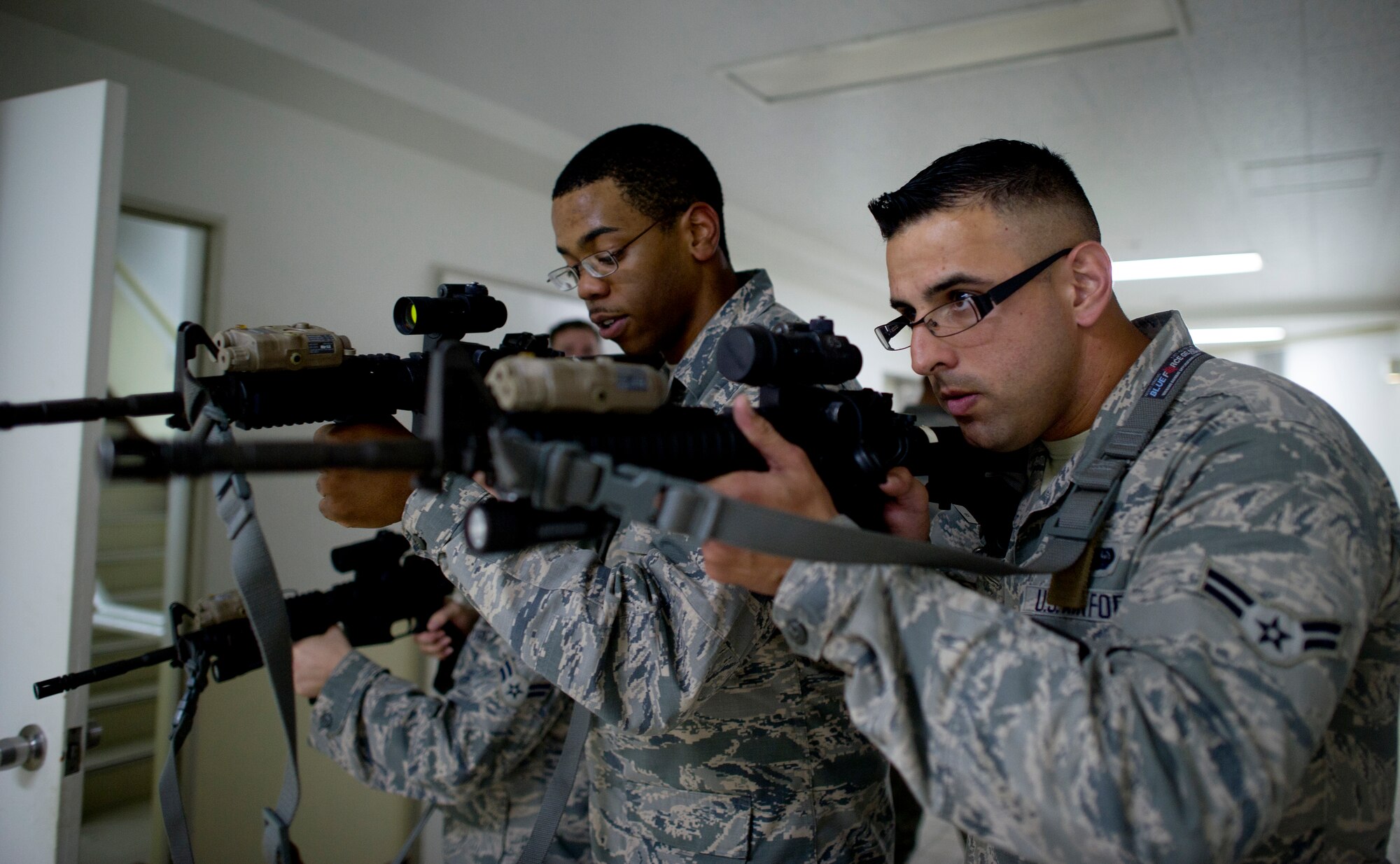 Airmen train with members from the 374th Security Forces squadron on how to clear a room during augmentee training Oct. 8, 2013, at Yokota Air Base, Japan. The training was conducted as part of Readiness Week at Yokota, which is focusing on a number of readiness related tasks and enhancing the wing's ability to generate aircraft under various conditions. (U.S. Air Force photo by Staff Sgt. Stacy Moless/released)