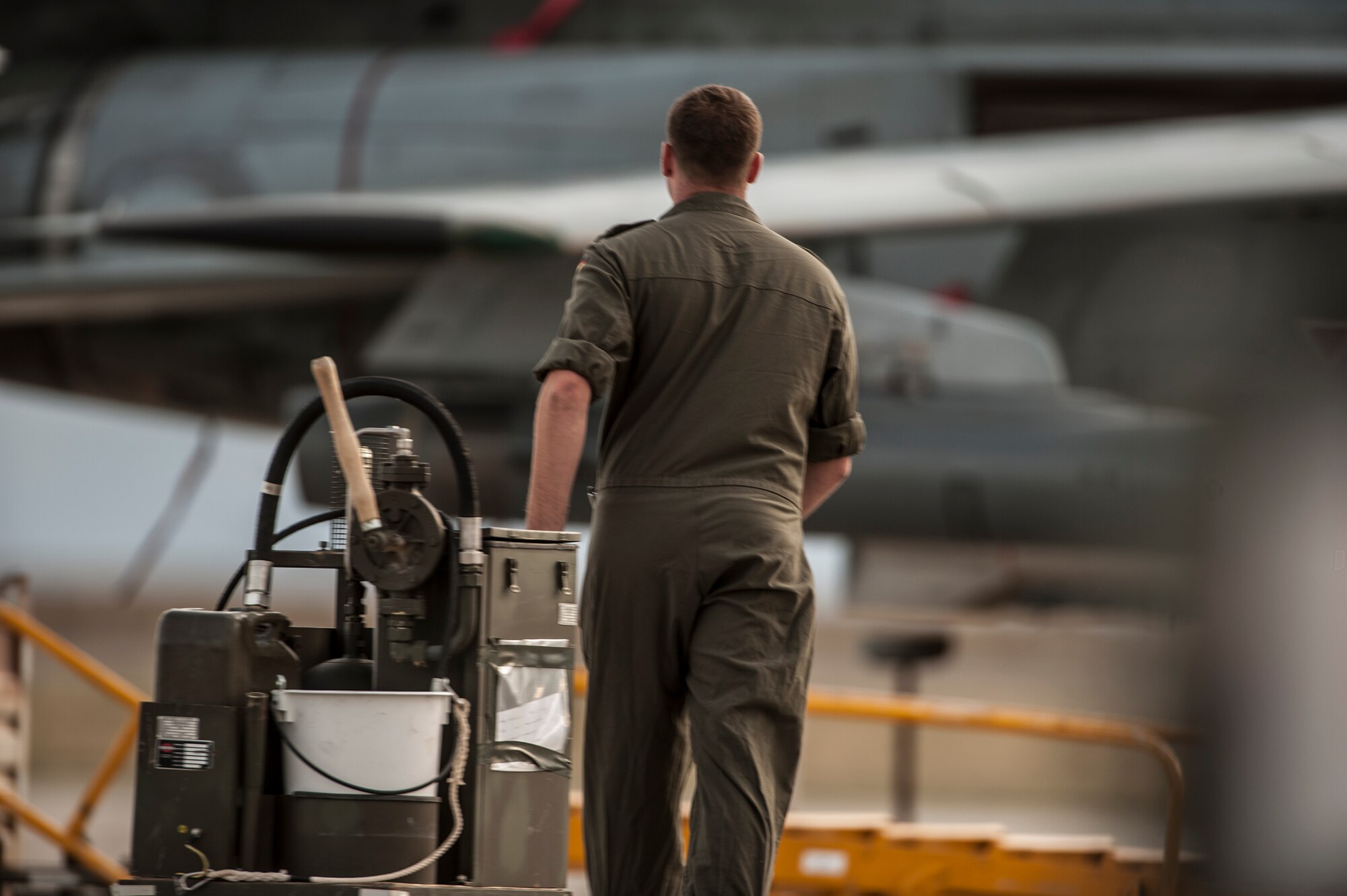 A German Air Force crew chief wheels a lubrication cart out to his AG-51 Tornado at Mountain Home Air Force Base, Idaho, Oct. 7, 2013, during exercise Mountain Roundup 2013. More than 300 Germans and Canadians, and an equal number of U.S. Navy, Marine Corps, Army and Air Force are participating in ground operations, close-air support, urban combatives, convoy operations, basic fighter maneuvers, counter air and multiple air-to-air training scenarios. (U.S. Air Force photo by Master Sgt. Kevin Wallace/RELEASED)