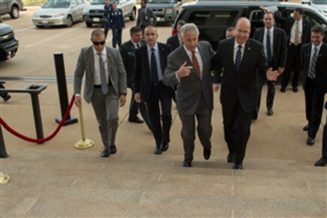 U.S. Defense Secretary Chuck Hagel escorts Israeli Defense Minister Moshe Ya'alon to a meeting at the Pentagon, Oct. 8, 2013. The two leaders met to discuss issues of mutual importance.