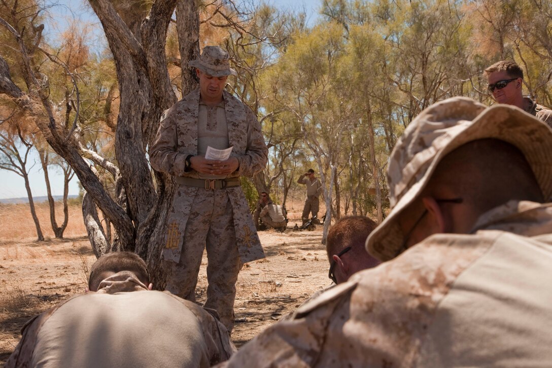 Navy LT. Charles S. Mallie, a chaplain with Battalion Landing Team 2nd Battalion, 4th Marines, 31st MEU, and a native of Surf City, N.J., holds a religious service in the field during Exercise Koolendong ’13 here, Sept. 9. The 31st MEU is the Marine Corps' force in readiness for the Asia-Pacific region and the only continuously forward-deployed MEU.