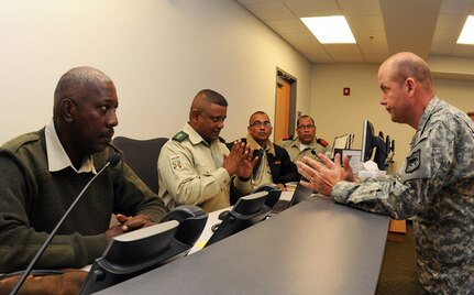 Army Lt. Col. Dan Iverson, assistant director of military support with the South Dakota Army National Guard, explains to Suriname army representatives how the South Dakota Guard responds to an emergency using the Joint Operations Center at Camp Rapid in Rapid City, S.D., May 8, 2012. Suriname and the SDNG have been exchanging ideas and developing a partnership since 2006 when the State Partnership Program was officially established for the two entities.