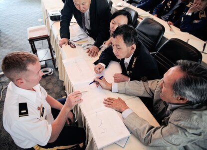 Army 1st Lt. Joshua Poling, of the West Virginia National Guard, points out safety devices to Mongolian mining officials on a map of his West Virginia mine. Three Soldiers from the West Virginia National Guard are sharing their mining knowledge to help decrease the amount of fatalities in the Mongolia mining industry.