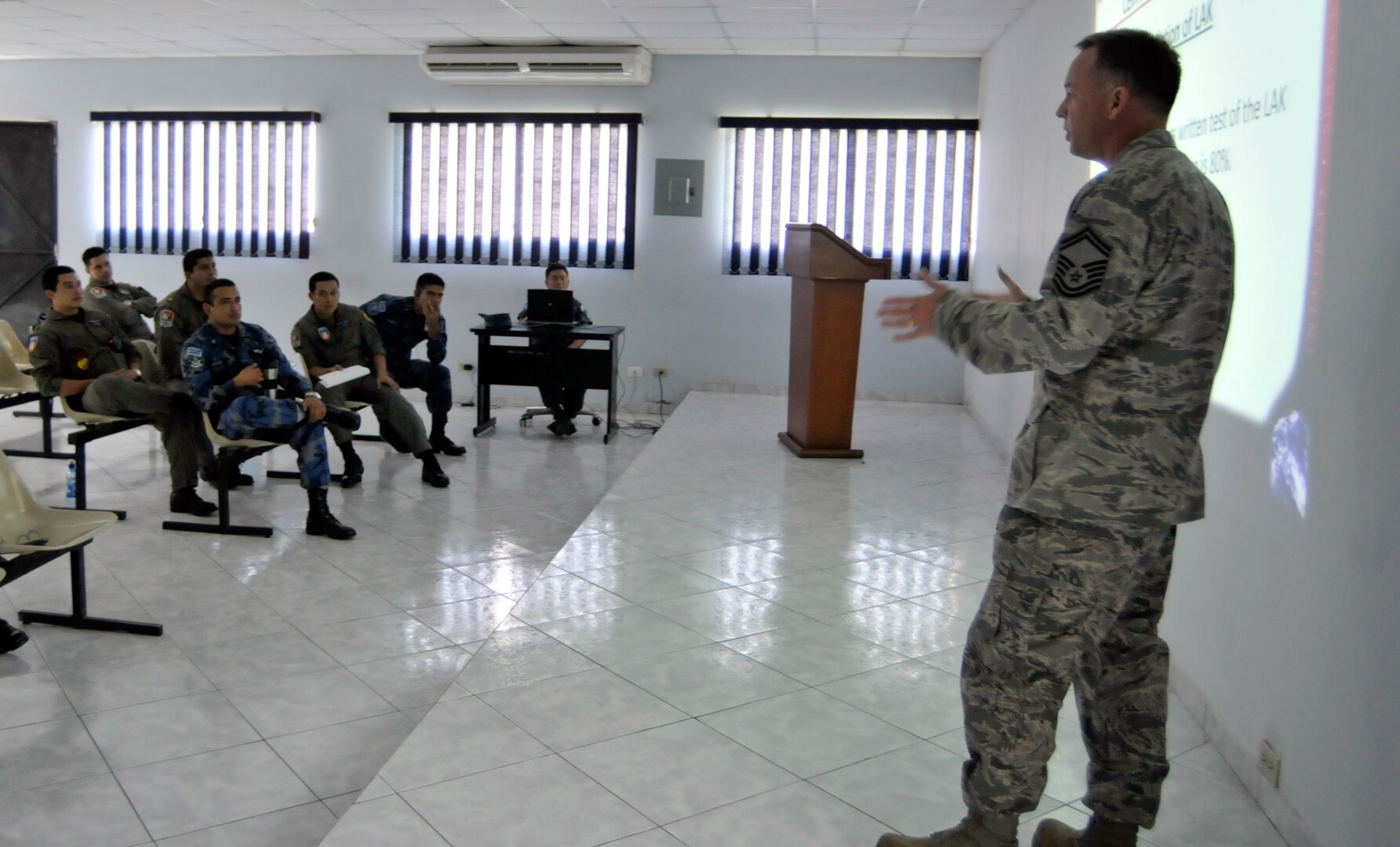 Air Force Senior Master Sgt. Richard Reed, 260th Air Traffic Control Squadron, briefs El Salvadoran air force air traffic controllers on how the New Hampshire Air National Guard trains their own air traffic controllers, as part of a weeklong subject matter expert exchange between the New Hampshire Air National Guard and the El Salvadoran air force, in San Salvador, El Salvador, May 7-11, 2012. This SMEE was part of the National Guard Bureau State Partnership Program.