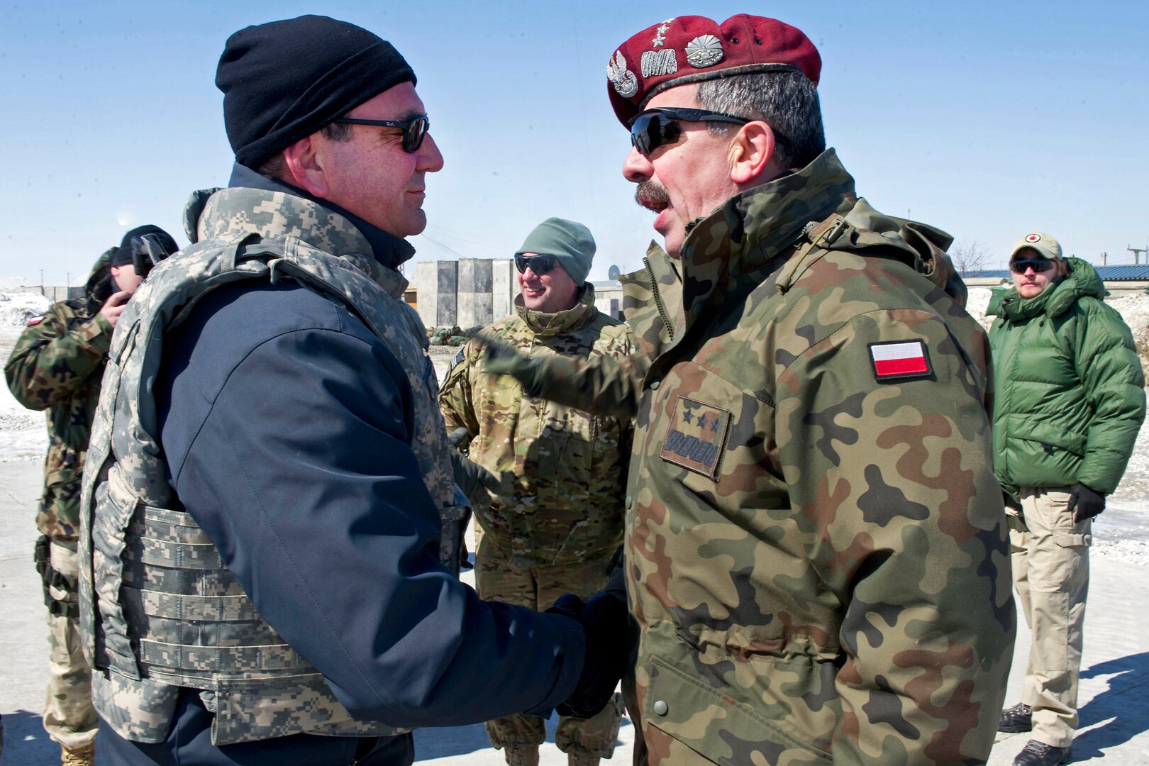 U.S. Deputy Defense Secretary Ashton B. Carter greets a Polish battle group commander on Forward Operating Base Ghazni, Afghanistan, Feb. 23, 2012. Carter is in Afghanistan meeting with troops and NATO members.