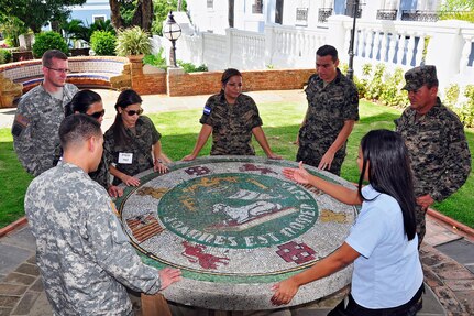 Honduran public affairs Soldiers observe a mosaic of Puerto Rico's crest during a visit to the governor's mansion in Old San Juan. The visit of the Honduran military was part of the State Partnership Program in which they had the opportunity to visit the Puerto Rico National Guard training facilities and exchange training information with its leaders.