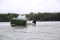 Marines with Bridge Company, 8th Engineer Support Battalion, 2nd Marine Logistics Group deploy an Improved Ribbon Bridge section at Engineer Point aboard Camp Lejeune, N.C., Oct. 8, 2013. Bridge Co. borrowed fuel from 2nd Tank Battalion, 2nd Marine Division for their operations in order to maintain their training as scheduled. (U.S. Marine Corps photo by Lance Cpl. Shawn Valosin)