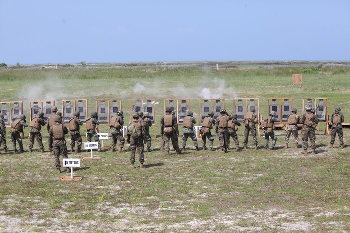 Philippine marines and U.S. Marines with Kilo Company, 3rd Battalion, 3rd Marine Regiment, assigned to the 3rd Marine Expeditionary Brigade, III Marine Expeditionary Force, engage targets using M16A4 rifles while conducting a stress shoot during Amphibious Landing Exercise (PHIBLEX) 14 at Naval Station Leovigildo Gantioqui in San Antonio, Zambales province, Philippines, Oct. 6, 2013. A stress shoot incorporated physical exercises before shooting to increase the service members' fatigue in order to simulate combat conditions. PHIBLEX is a bilateral training exercise designed to improve the interoperability, readiness and professional relationships between the U.S. Marine Corps and partner nations.