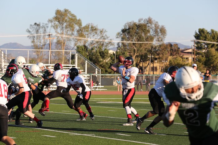 Casey Rogers, Falcon's quarterback,throws a pass against the 1st Radio Battalion Freqs at Paige Field House aboard Marine Corps Base Camp Pendleton, Calif., Oct. 7. The Falcons suffered their first lose of the season moving their record to 5-1. 