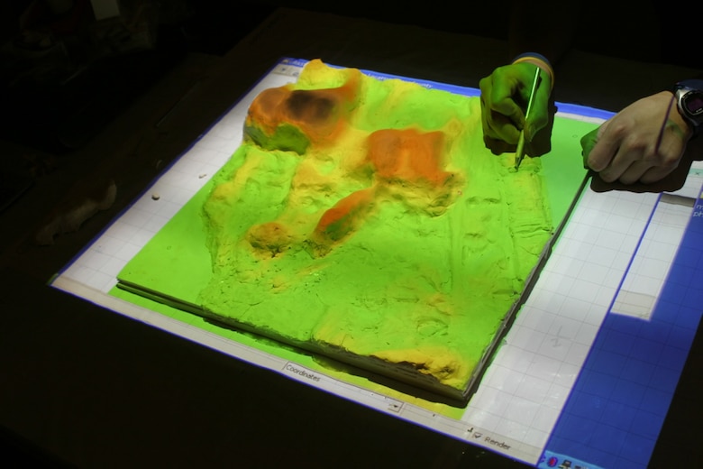 This image shows the Tangible Geospatial Modeling System (TanGeoMS) at North Carolina State University used for analyzing relationships between the morphology of elevation surfaces and dynamic landscape processes.  A flexible physical model can be modified by hand and scanned to create digital representations of altered landscapes within a geographic information system.